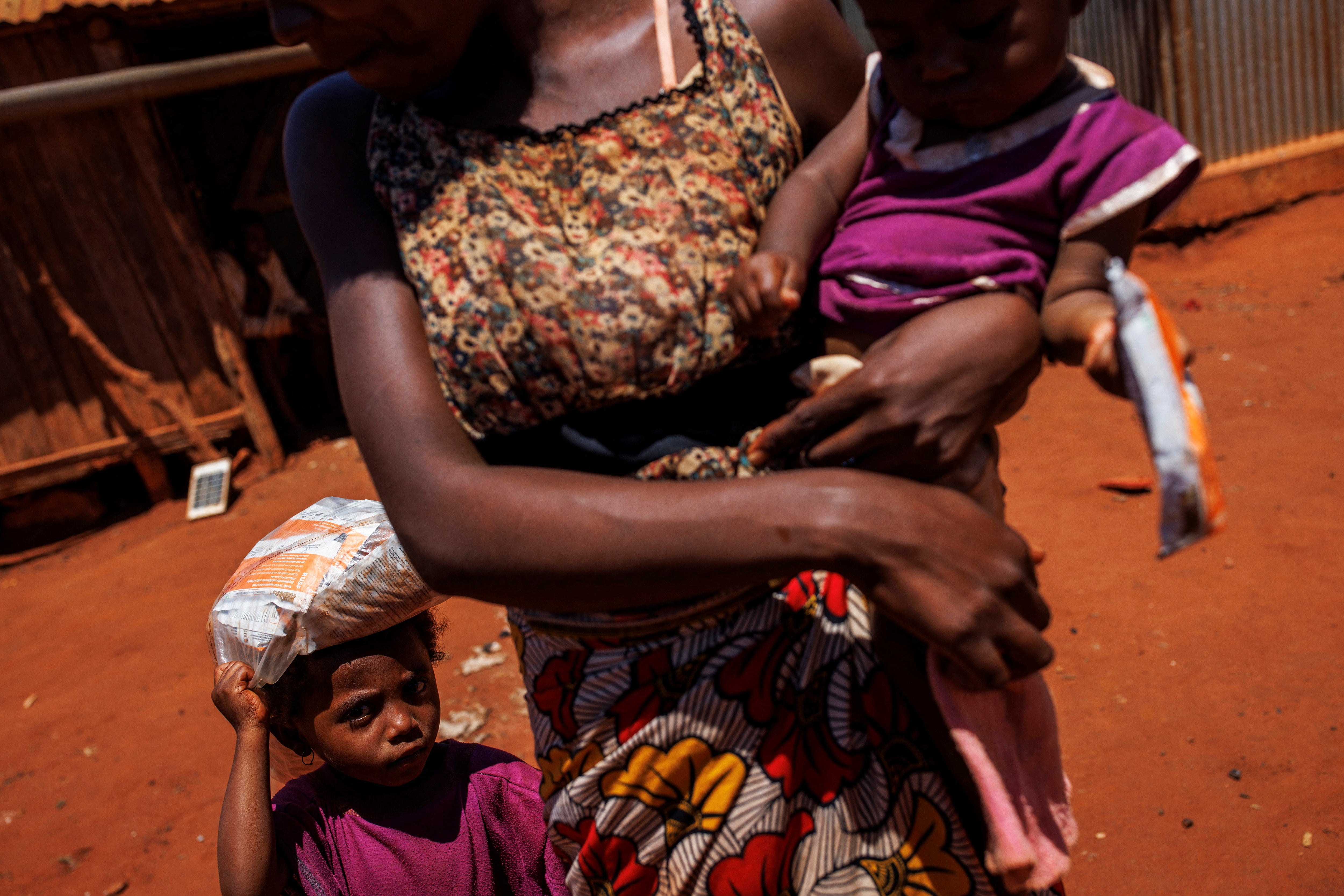 A mother and her two children leave a children’s malnutrition post run by the World Food Programme in Anjeky Beanatara, Androy region