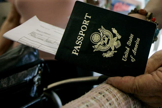 <p>Travelers take out their passports before checking in at San Diego International Airport January 8, 2006 in San Diego, California</p>