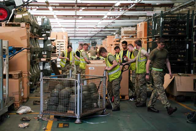 Members of the military pack thousands of surplus helmets donated by the army for ‘Hats off to Ukraine’, at MOD Donnington in Shropshire. Thirty members of the Midlands’ based “Poachers”, from 2nd Battalion The Royal Anglian Regiment, have sorted and packed 84,000 surplus helmets bound for the Ukrainian military in just two weeks, and are now in the final push to pack up all the helmets by Friday. Picture date: Thursday March 31, 2022.