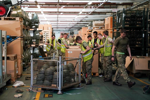 Members of the military pack thousands of surplus helmets donated by the army for ‘Hats off to Ukraine’, at MOD Donnington in Shropshire. Thirty members of the Midlands’ based “Poachers”, from 2nd Battalion The Royal Anglian Regiment, have sorted and packed 84,000 surplus helmets bound for the Ukrainian military in just two weeks, and are now in the final push to pack up all the helmets by Friday. Picture date: Thursday March 31, 2022.