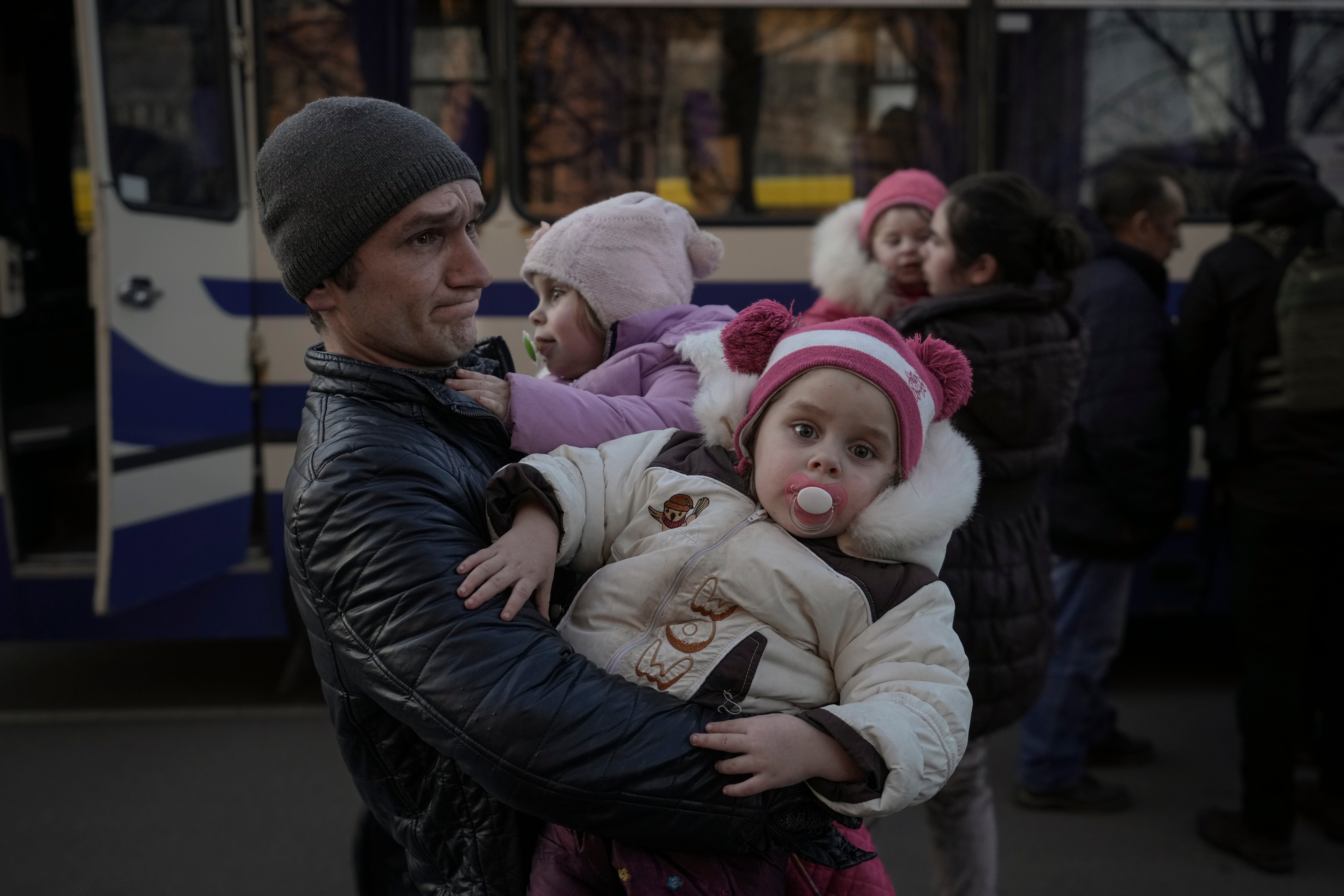 Refugees wait for Ukrainian police to check their papers and belongings (Vadim Ghirda/AP/PA)