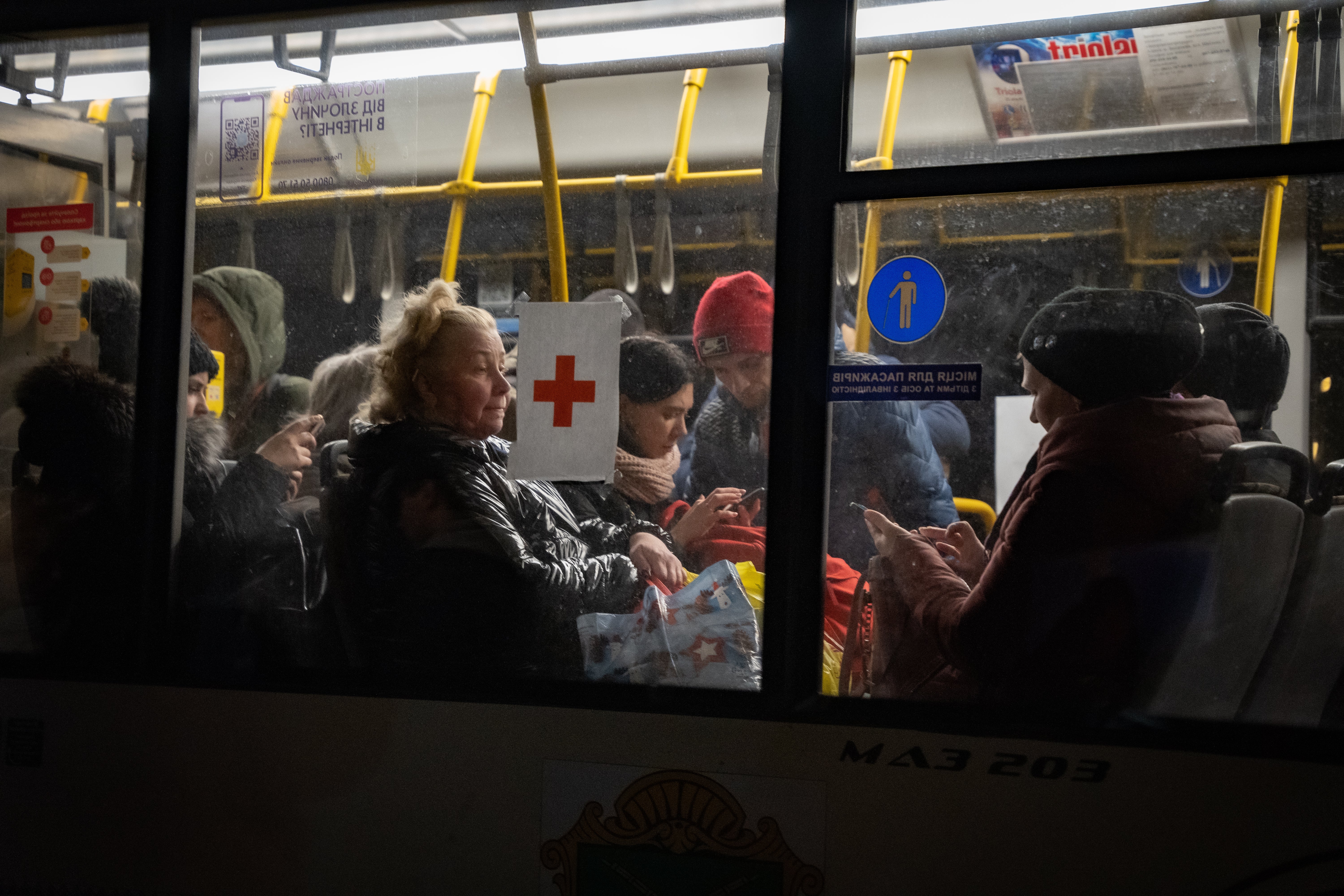 Refugees who have just fled Mariupol in their own cars and on foot take an evacuation bus to the city of Zaporizhzhia