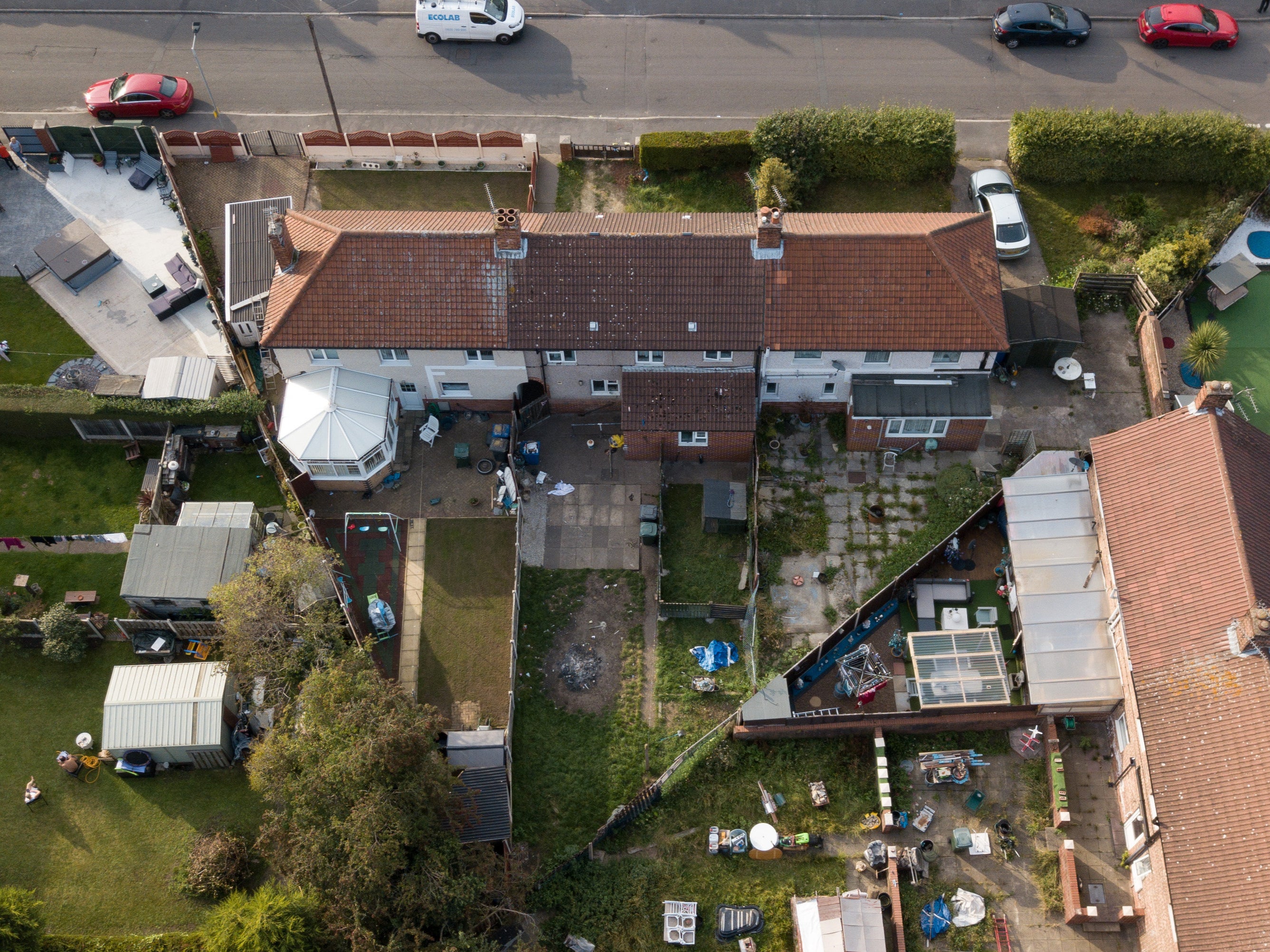 A dog pen can be seen in the rear garden of the house (centre) where 12-day-old Elon Jase Ellis-Joynes was mauled to death