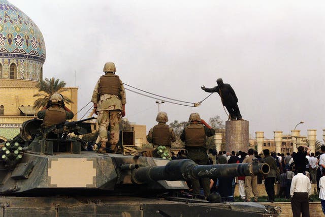<p>US marines and Iraqis are seen on 9 April 2003 as the statue of Iraqi dictator Saddam Hussein is toppled at al-Fardous square in Baghdad, Iraq</p>