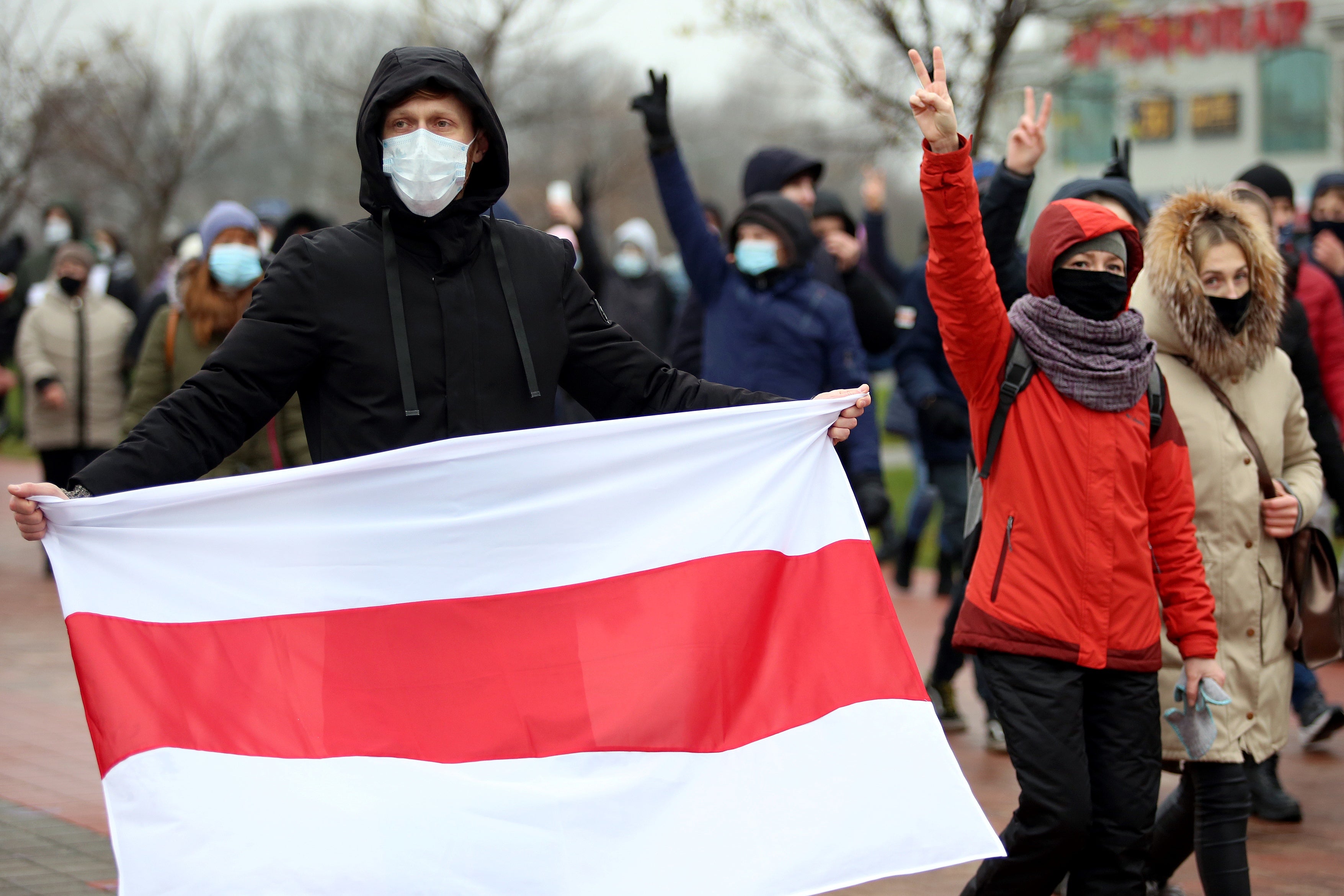 Opposition supporters parade through the streets of Minsk during a rally to protest against police violence and the allegedly fraudulent presidential election, 22 November 2020