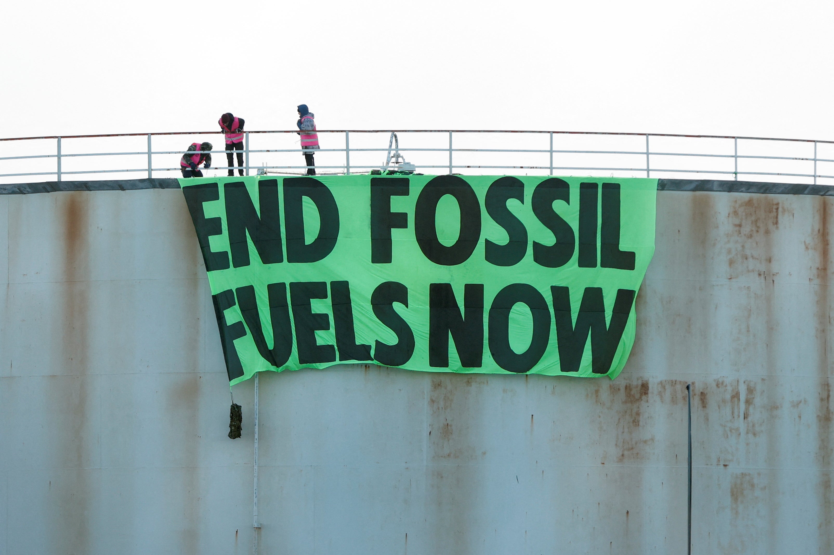 Extinction Rebellion activists protest at an Esso storage tank in London.