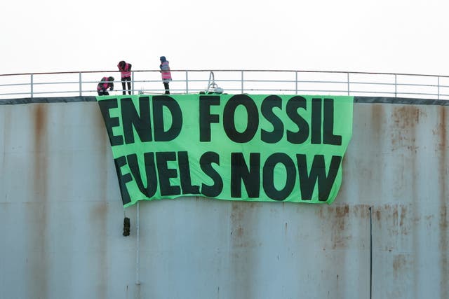 <p>Extinction Rebellion activists protest at an Esso storage tank in London.  </p>