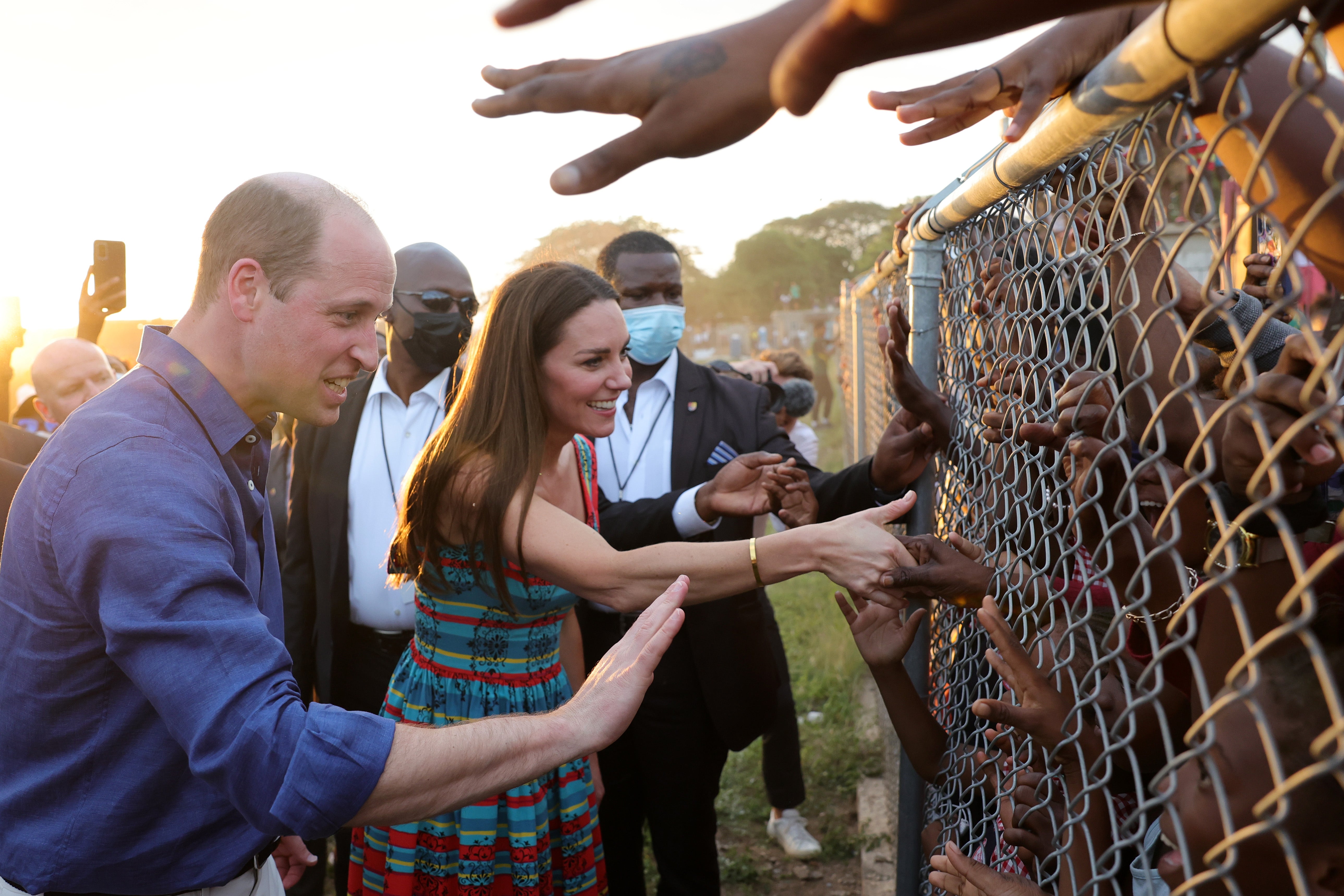 Images like this, of Prince William and Kate Middleton shaking hands with children behind a fence in Trench Town, were criticised
