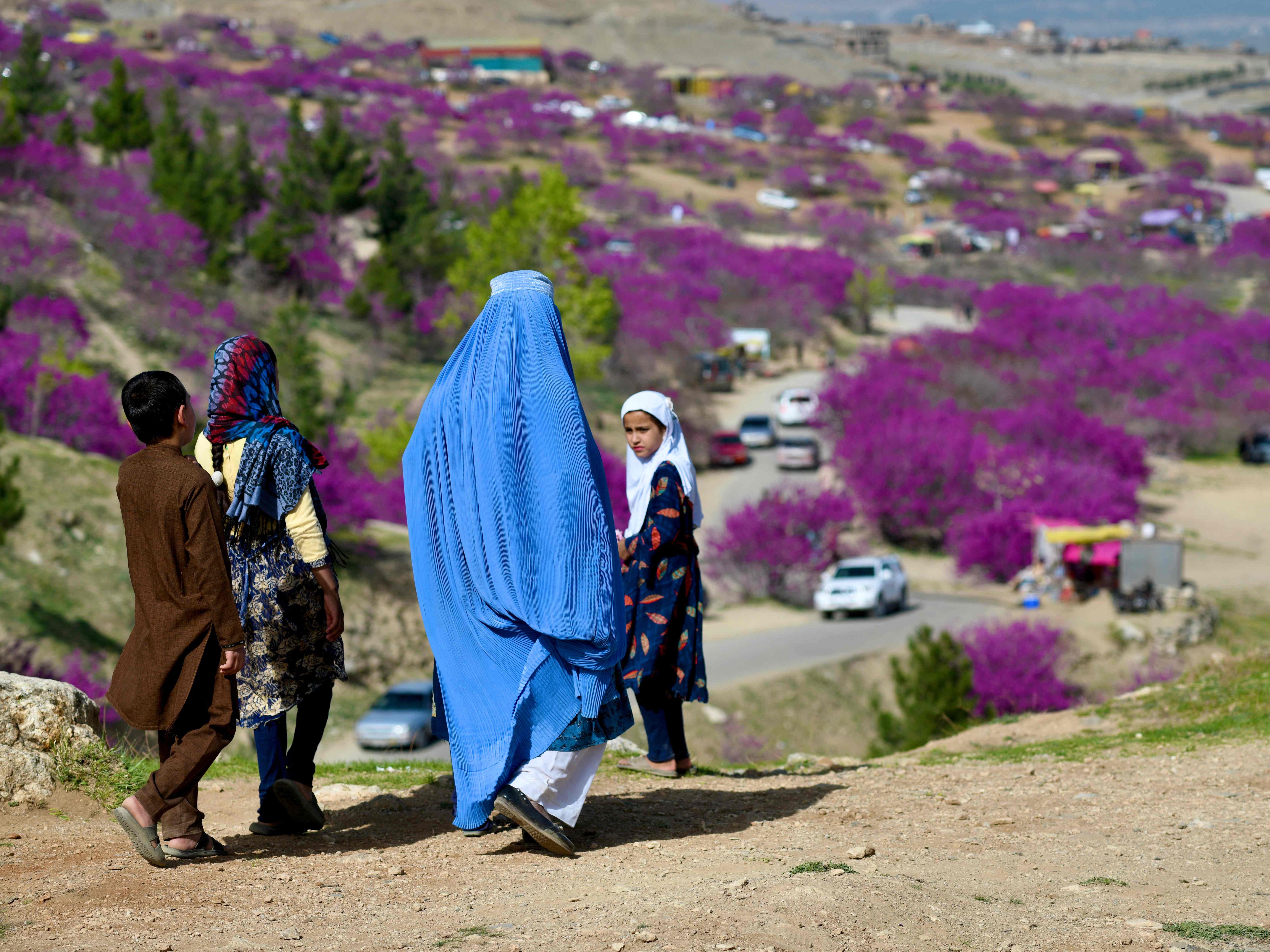 File A burqa-clad woman along with children visit the Gol Ghandi Park in Charikar of Parwan province
