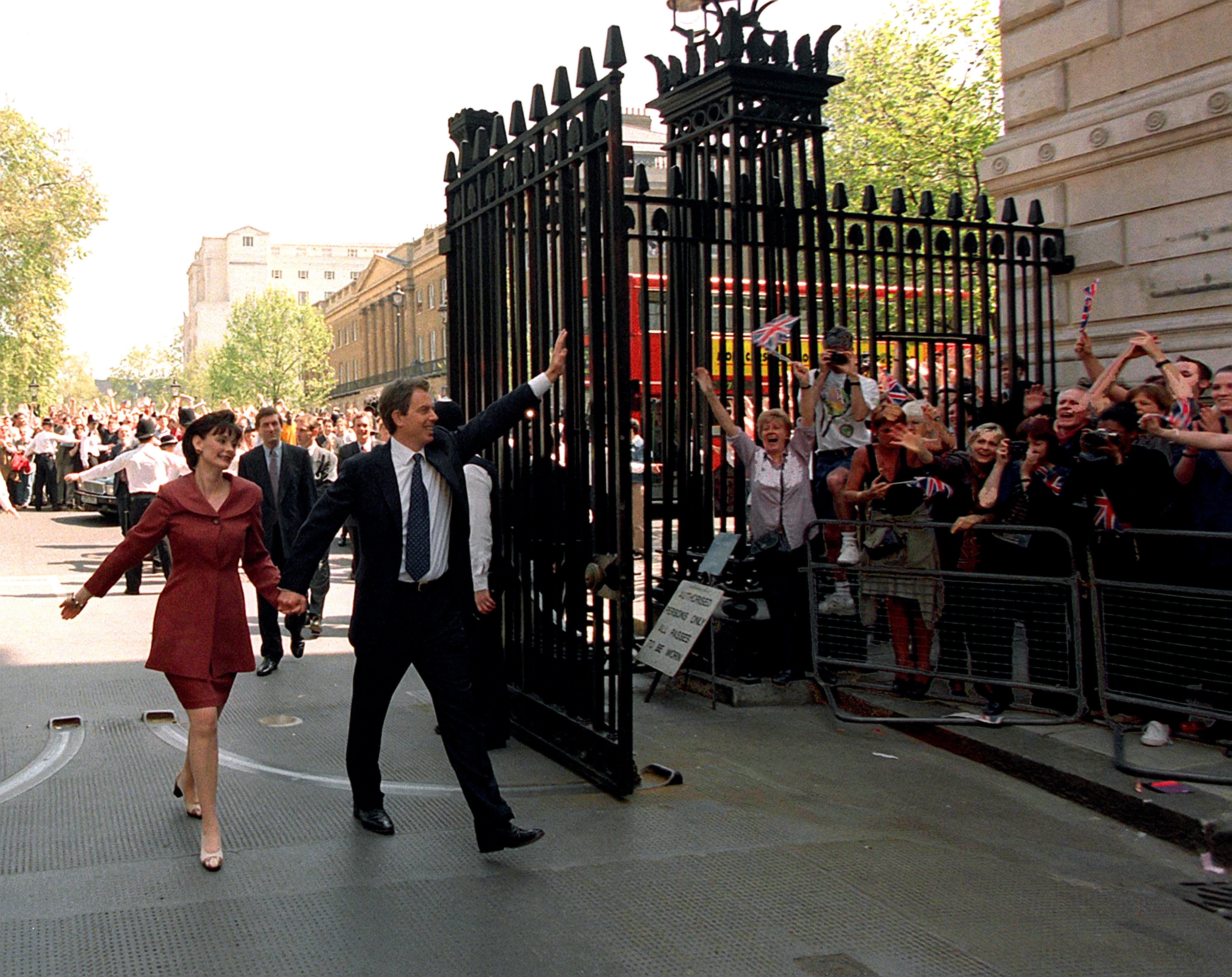 Tony Blair and his wife, Cherie, walk hand in hand into Downing Street the morning after the 1997 general election