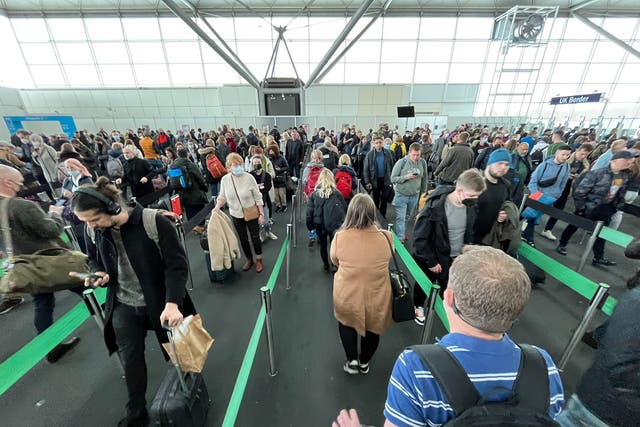 <p>Welcome sight? Arrivals queuing for passport control at London Stansted airport</p>
