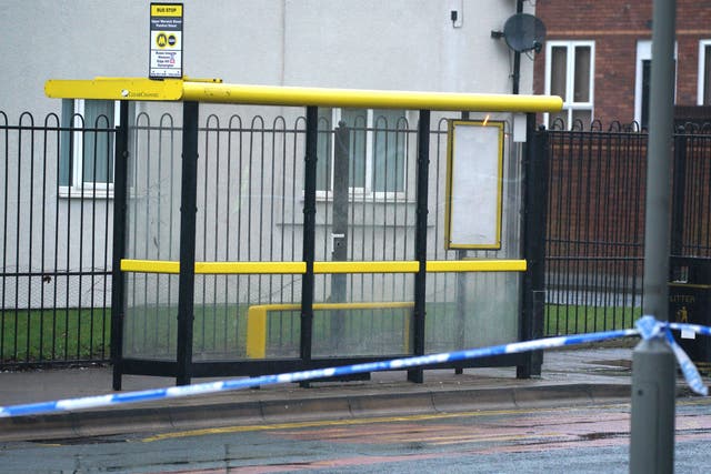 Police forensic tape marks a bullet hole in a bus stop in Upper Warwick Street in Toxteth, Liverpool (PA)