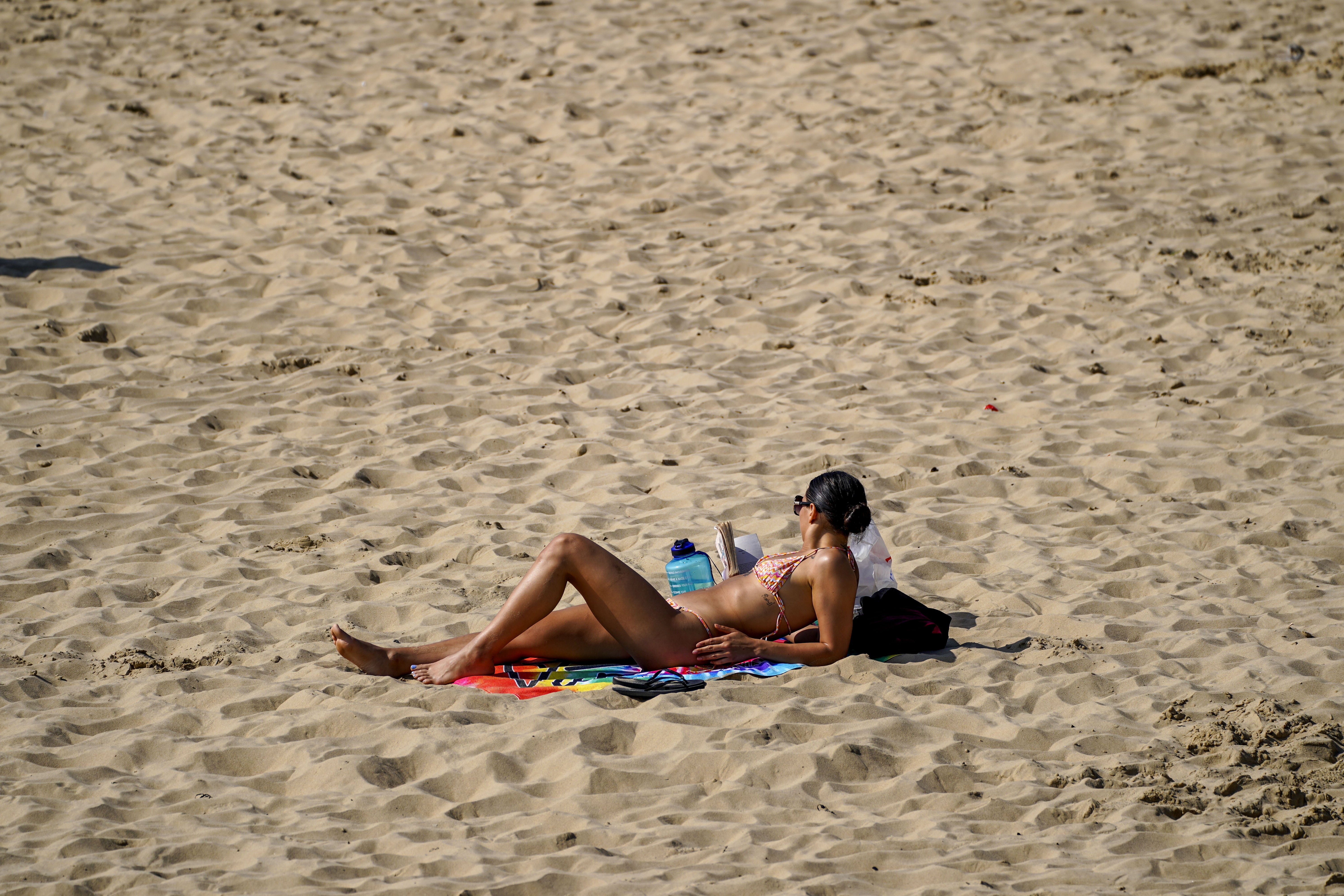 A sunbather enjoys the Mother’s Day sunshine in Bournemouth, Dorset (Steve Parsons/PA).