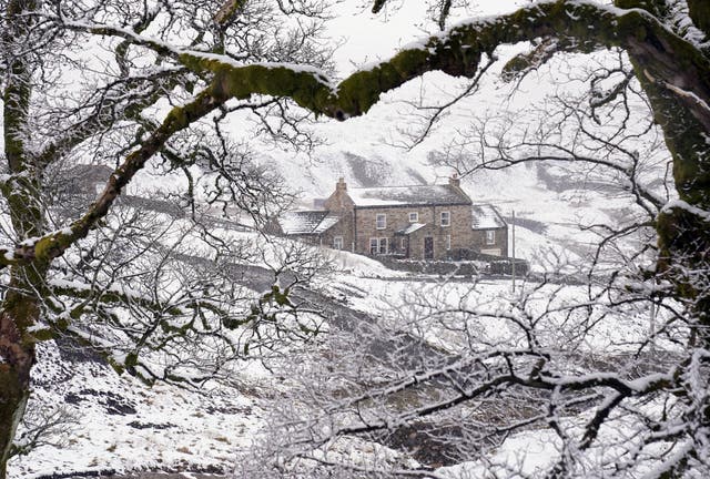 A cottage near Carrshield in Northumberland is surrounded by snow (PA)