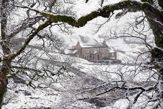 A cottage near Carrshield in Northumberland is surrounded by snow (PA)