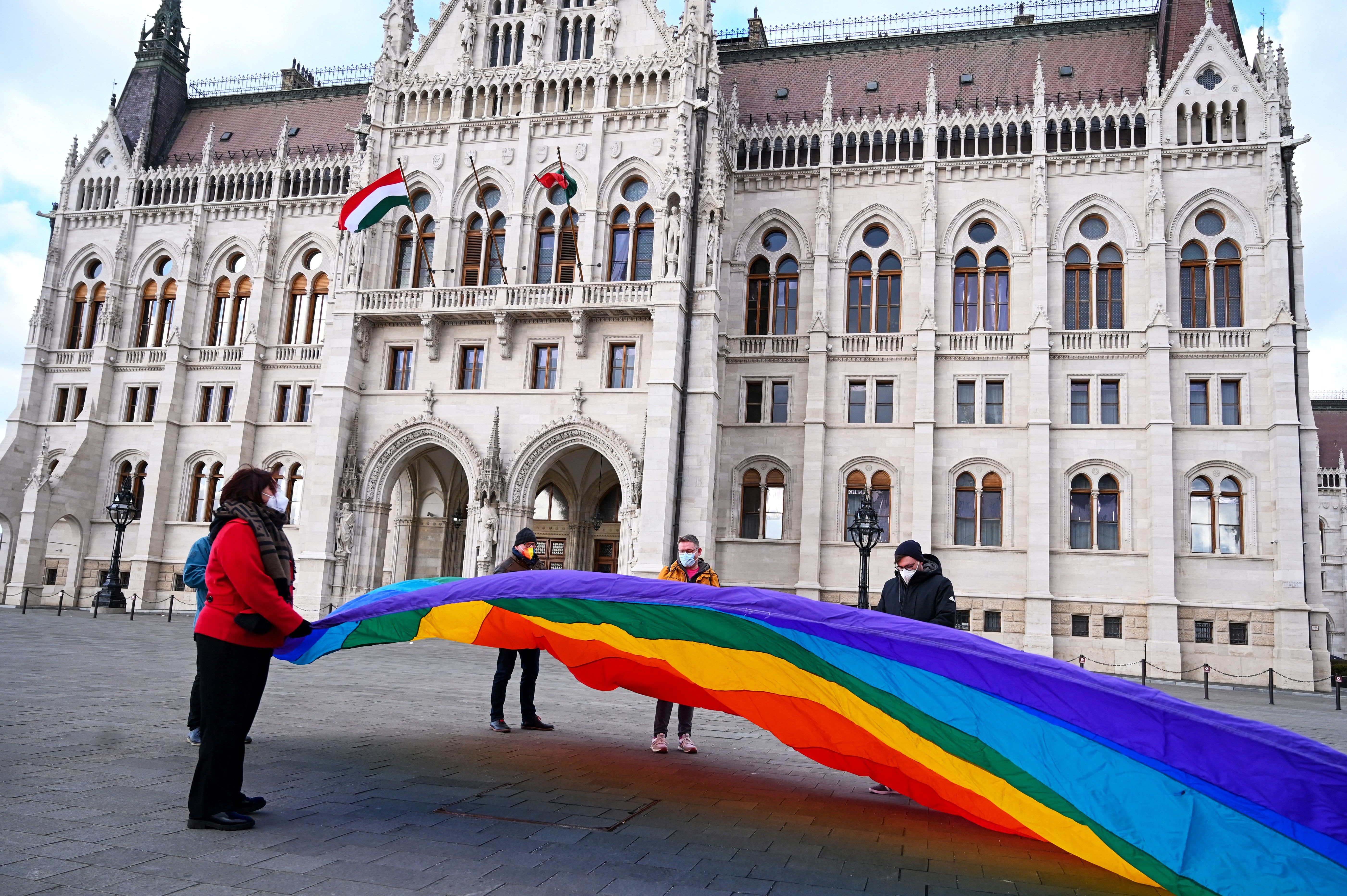 LGBTQ+ activists deploy a 30-metre-long rainbow-coloured flag in front of the Hungarian parliament building, 21 January 2022