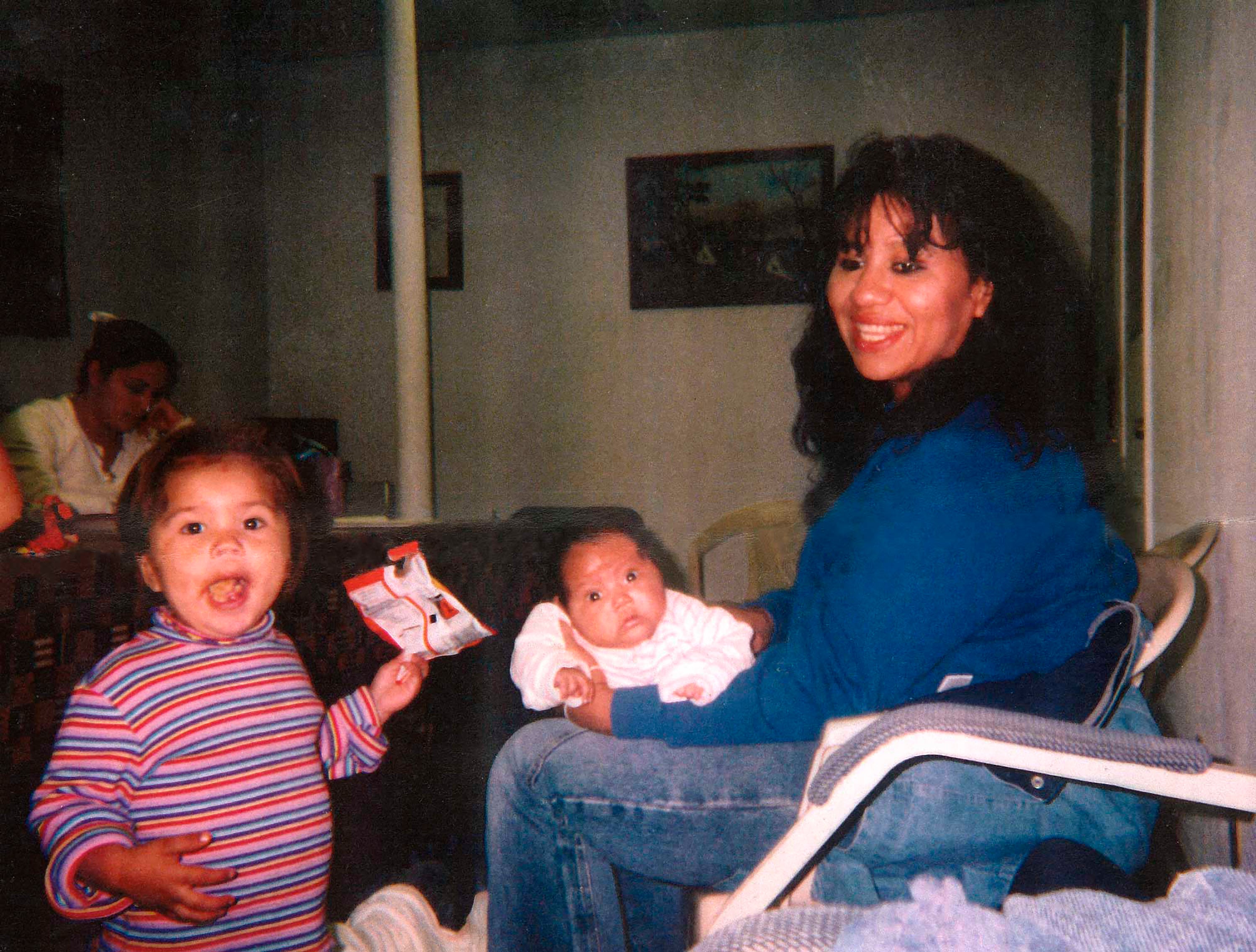 In this undated photo, Melissa Lucio holds her daughter Mariah, while her other child stands nearby