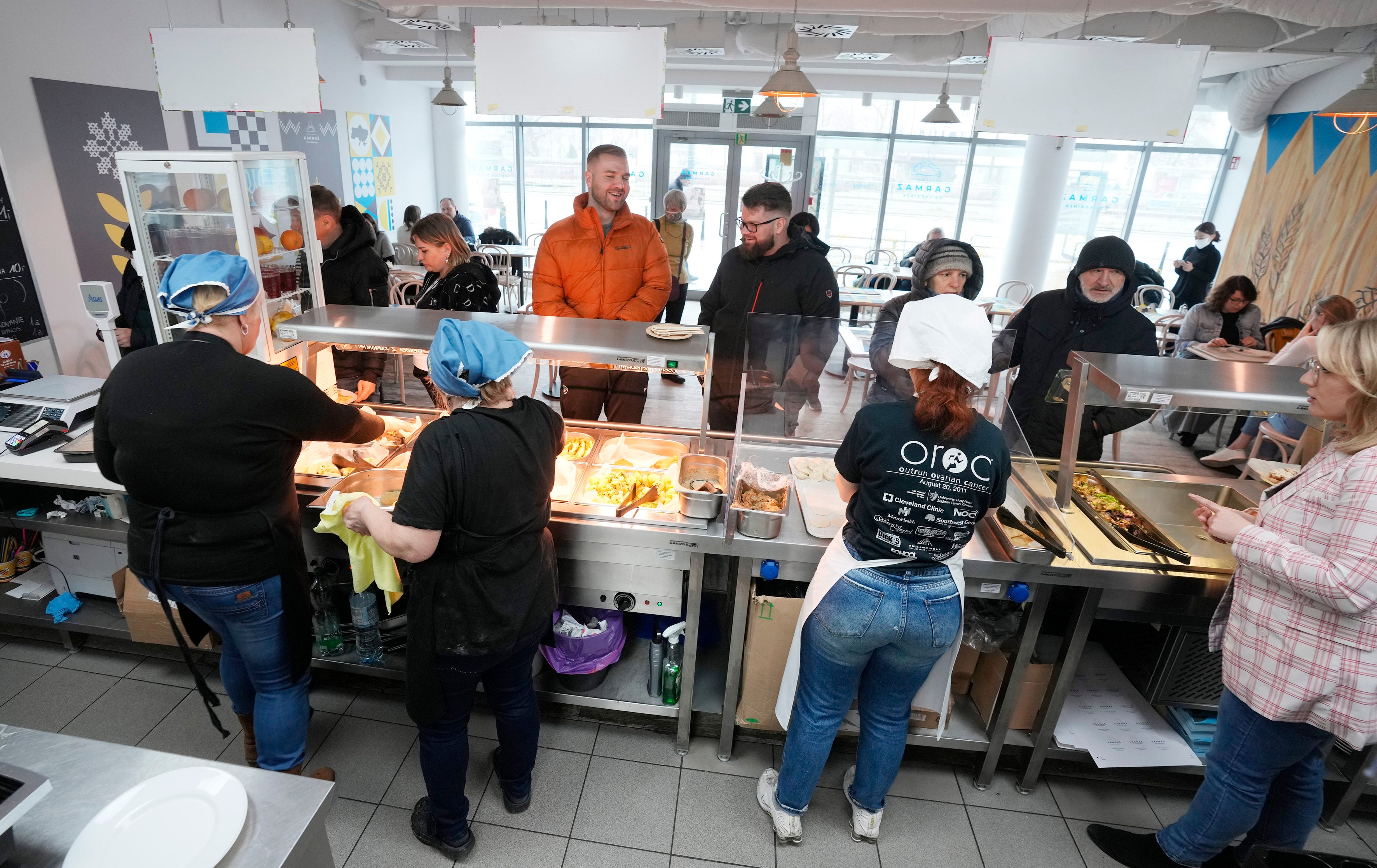 The refugees roll out dough and chop fillings for traditional Ukrainian dumplings