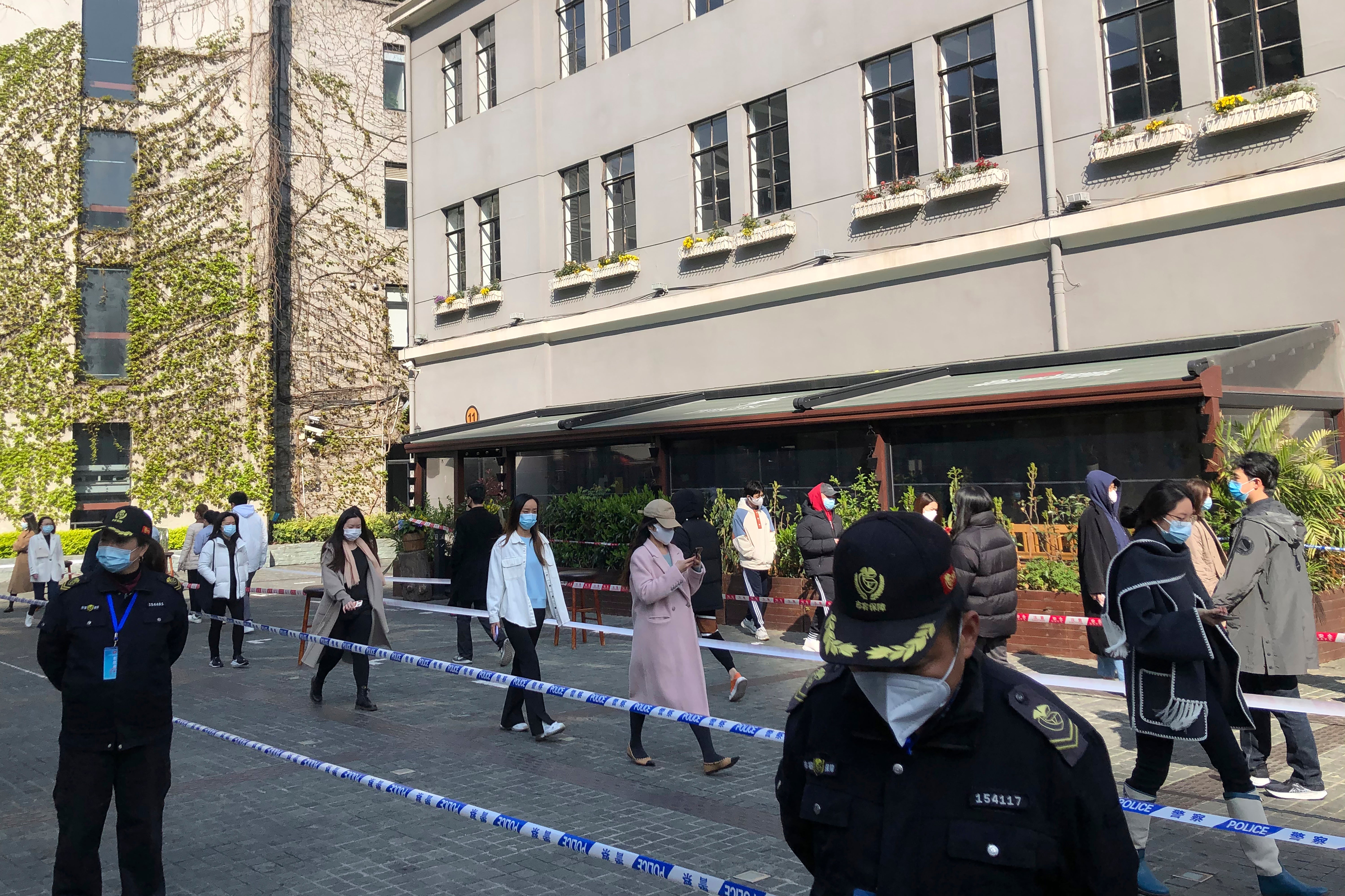 Residents line up for mass testing in a locked down area in Jingan district of western Shanghai on 4 April