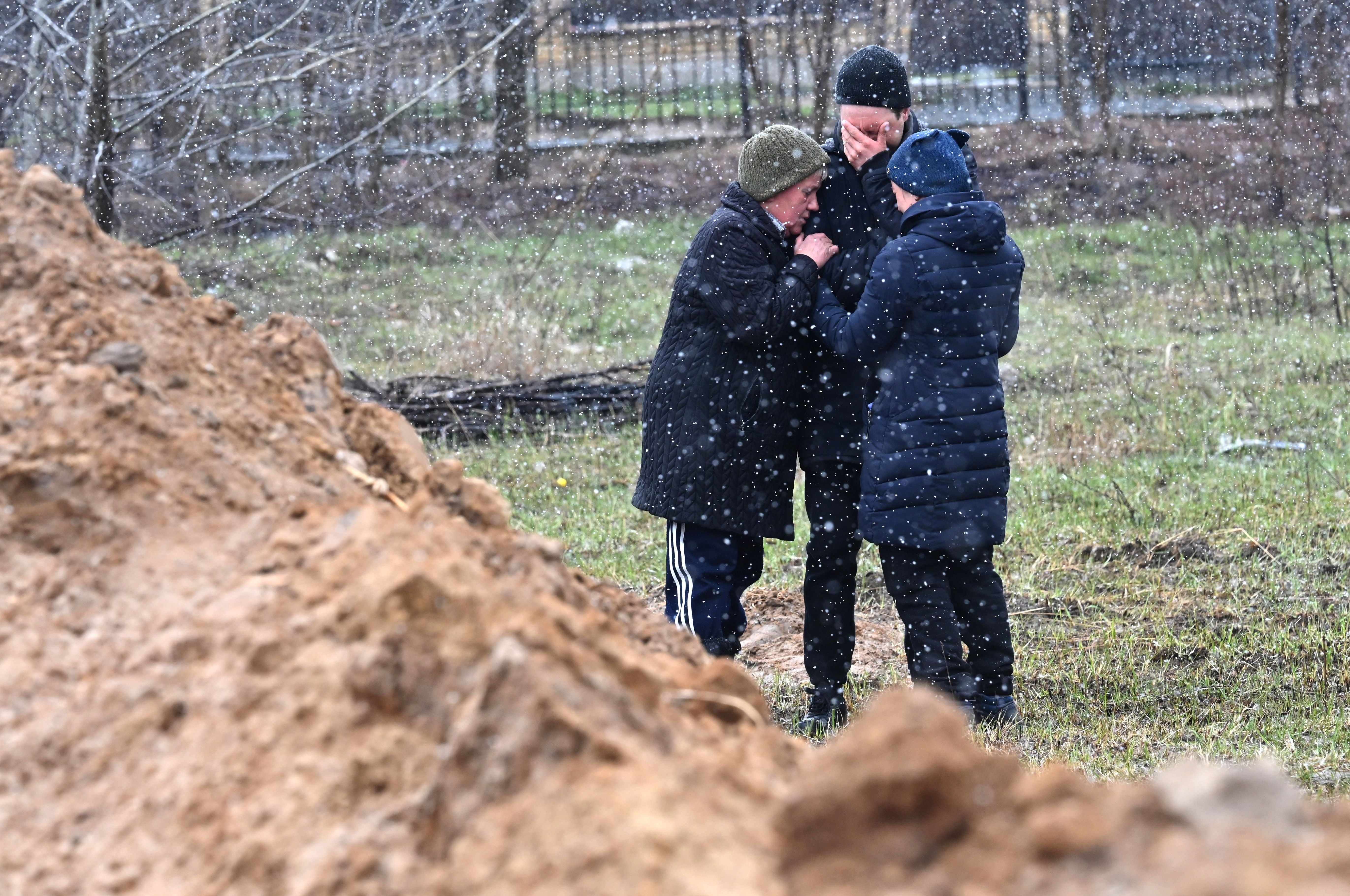 Residents at a mass grave in the town of Bucha, just northwest of the Ukrainian capital Kyiv