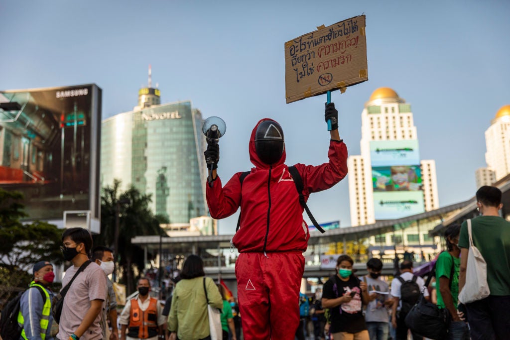 A Thai anti-government protester dresses up as a character from Squid Games during 2021 rally