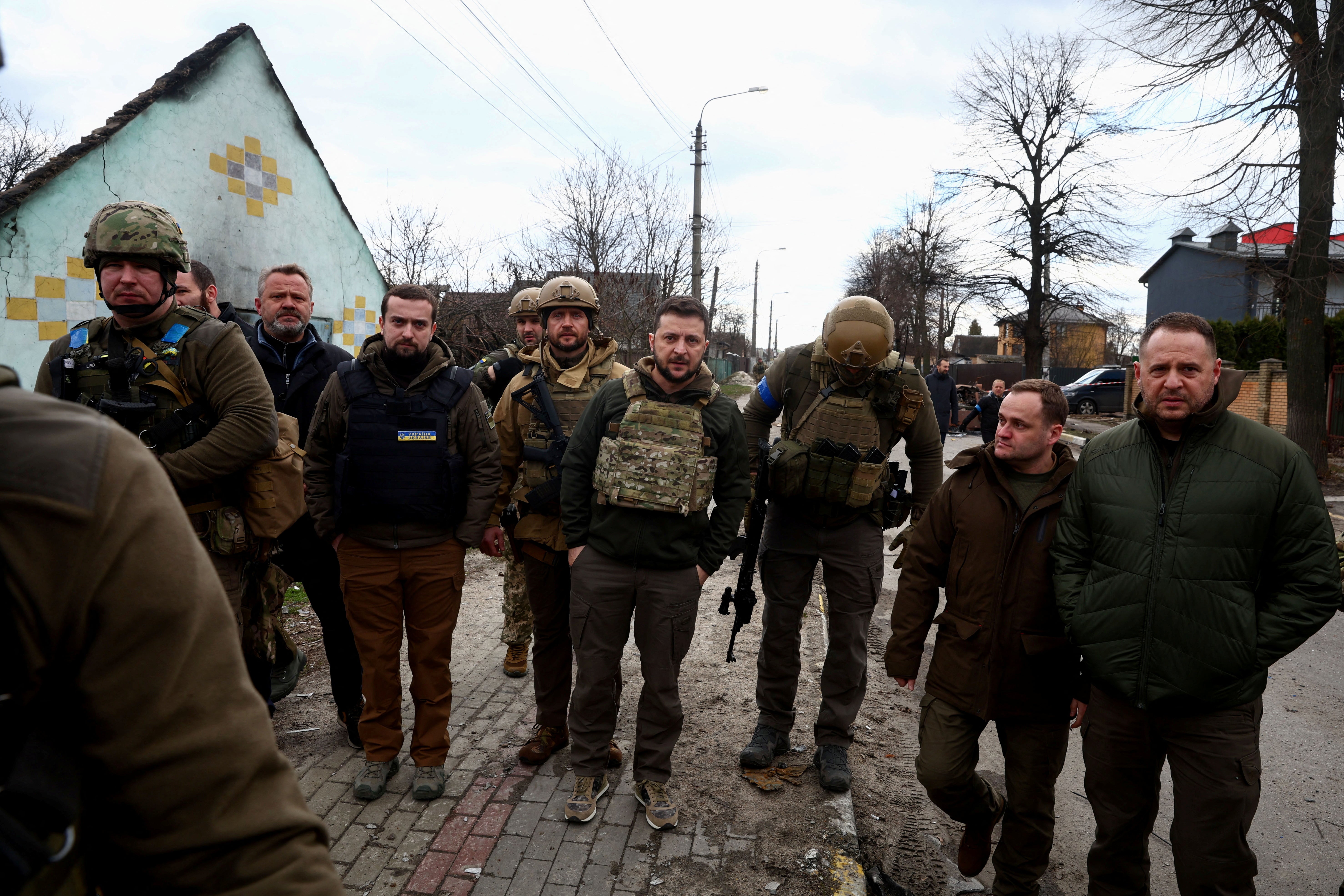 Zelensky looks on as he stands with a number of Ukrainian servicemen