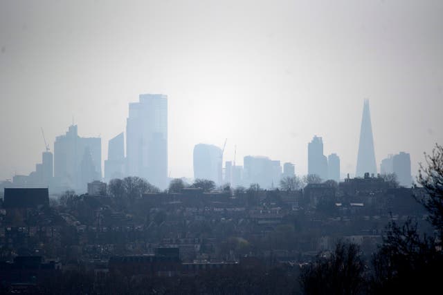 The City of London skyline viewed through the haze from Alexandra Palace (PA)