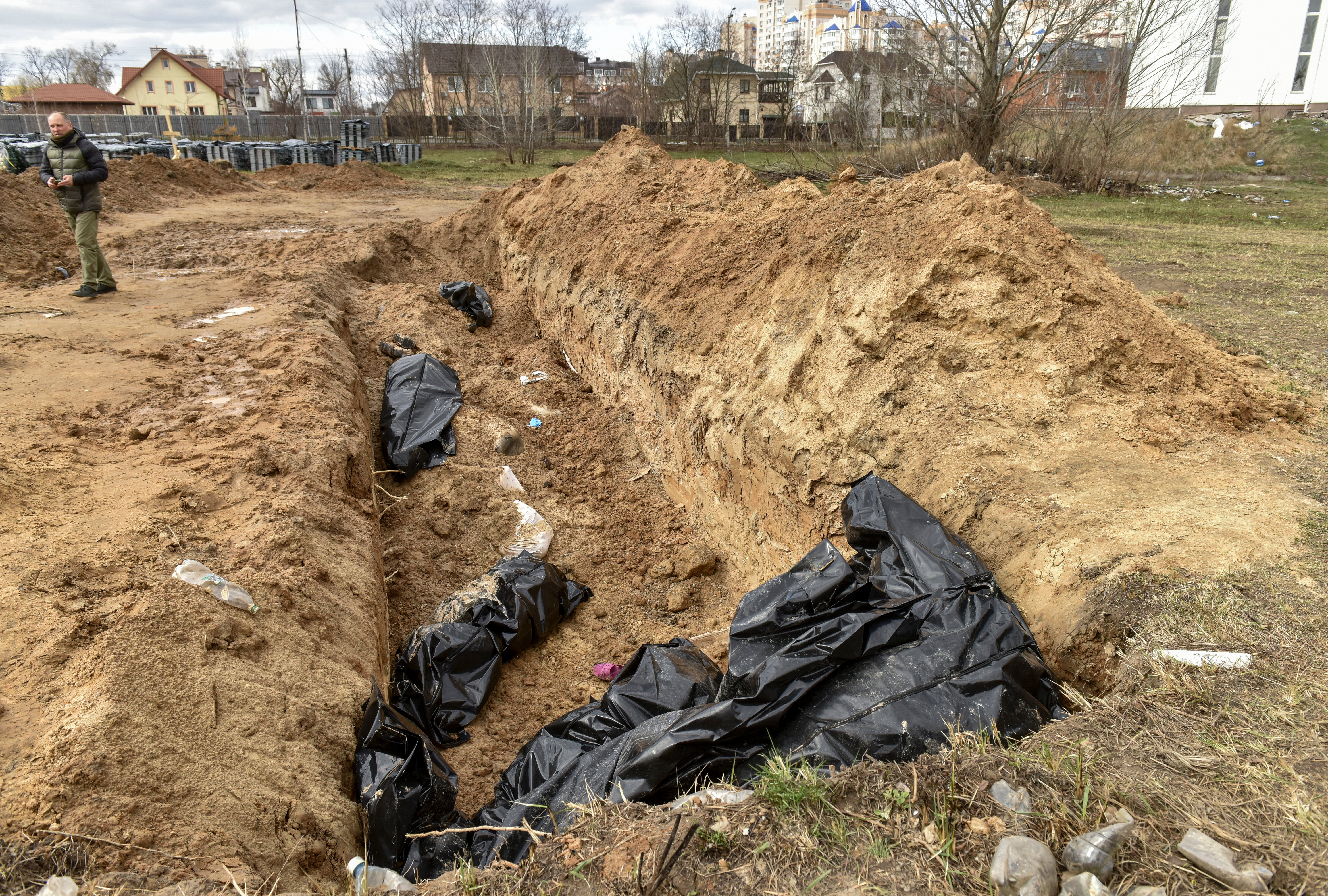 Bodies of civilians in plastic bags lay in a mass grave in Bucha