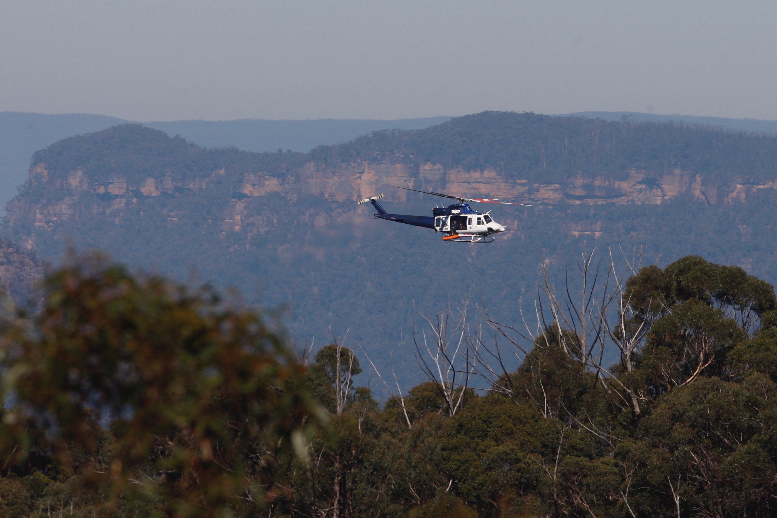 A helicopter recovers the bodies at Wentworth Falls in the Blue Mountains, Australia, on Tuesday