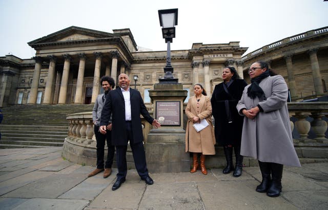 Andrew Lynch (2nd left) the son of Eric Lynch during the unveiling of the bronze plaque close to the World Museum on William Brown Street, Liverpool, which explains the history behind the street name and its origins with the slave trade (Peter Byrne/PA)