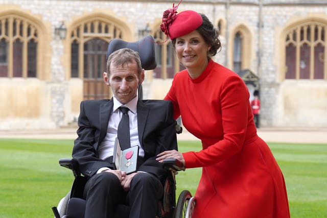 <p>Robert Burrow with his wife Lindsey after he was made an MBE by the Princess Royal (Steve Parsons/PA)</p>