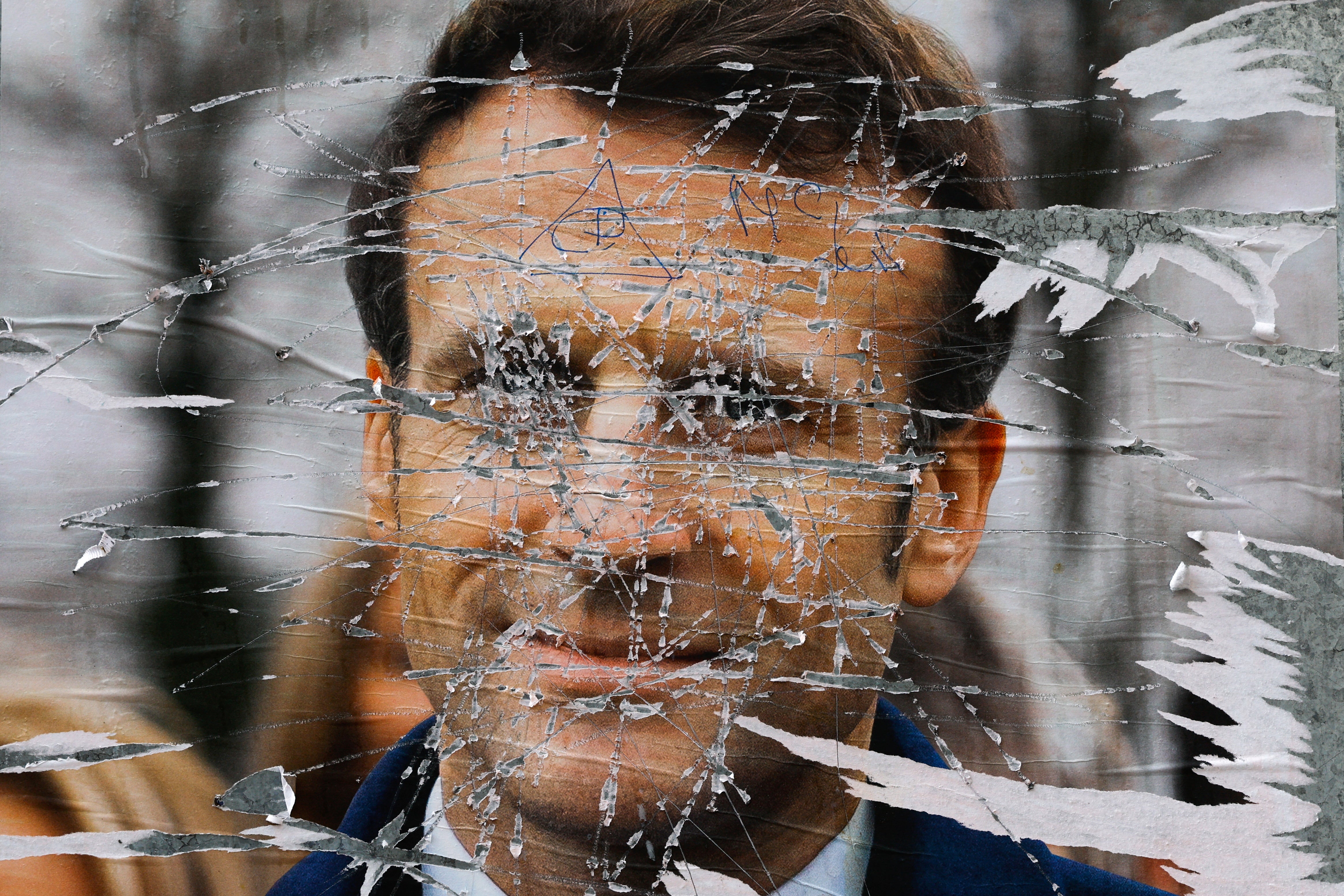 A presidency in shreds? A ripped presidential election campaign poster of Emmanuel Macron