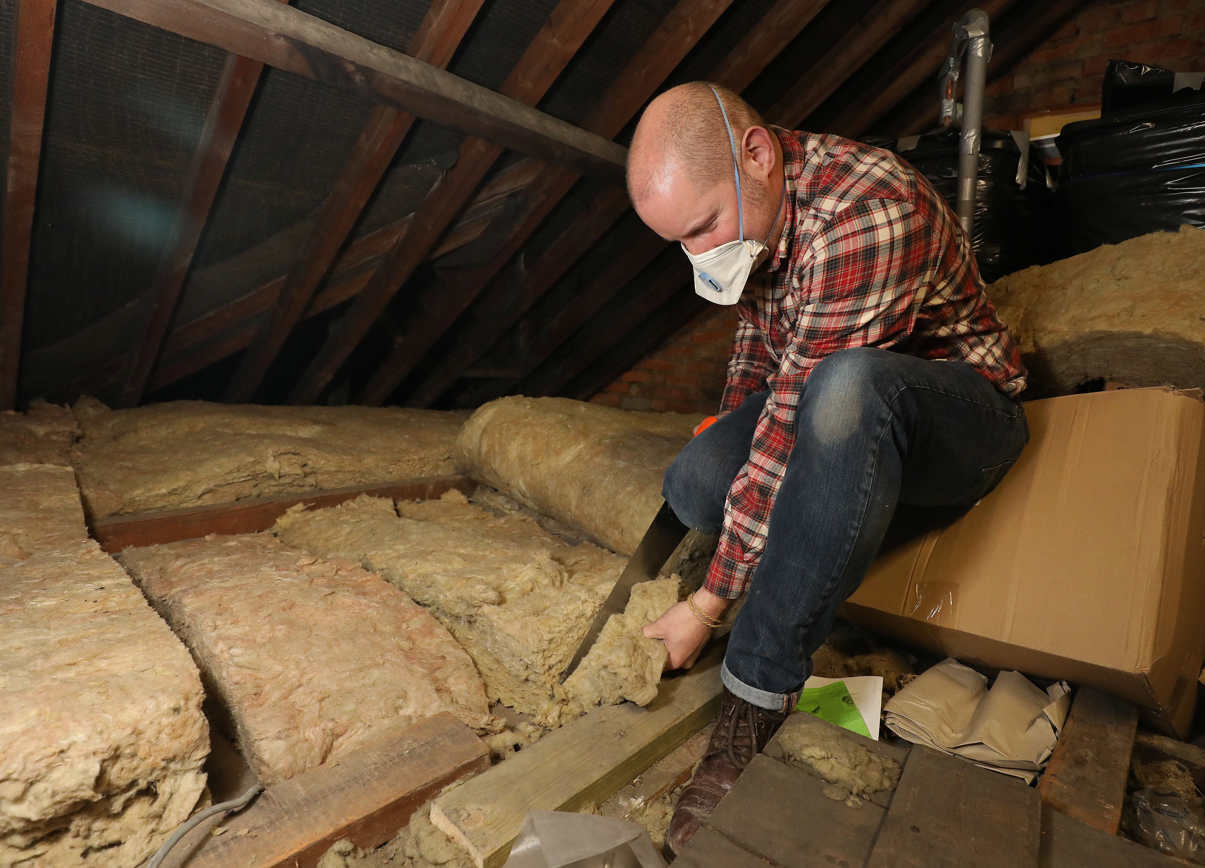 Fitting insulation in a loft (Philip Toscano/PA)