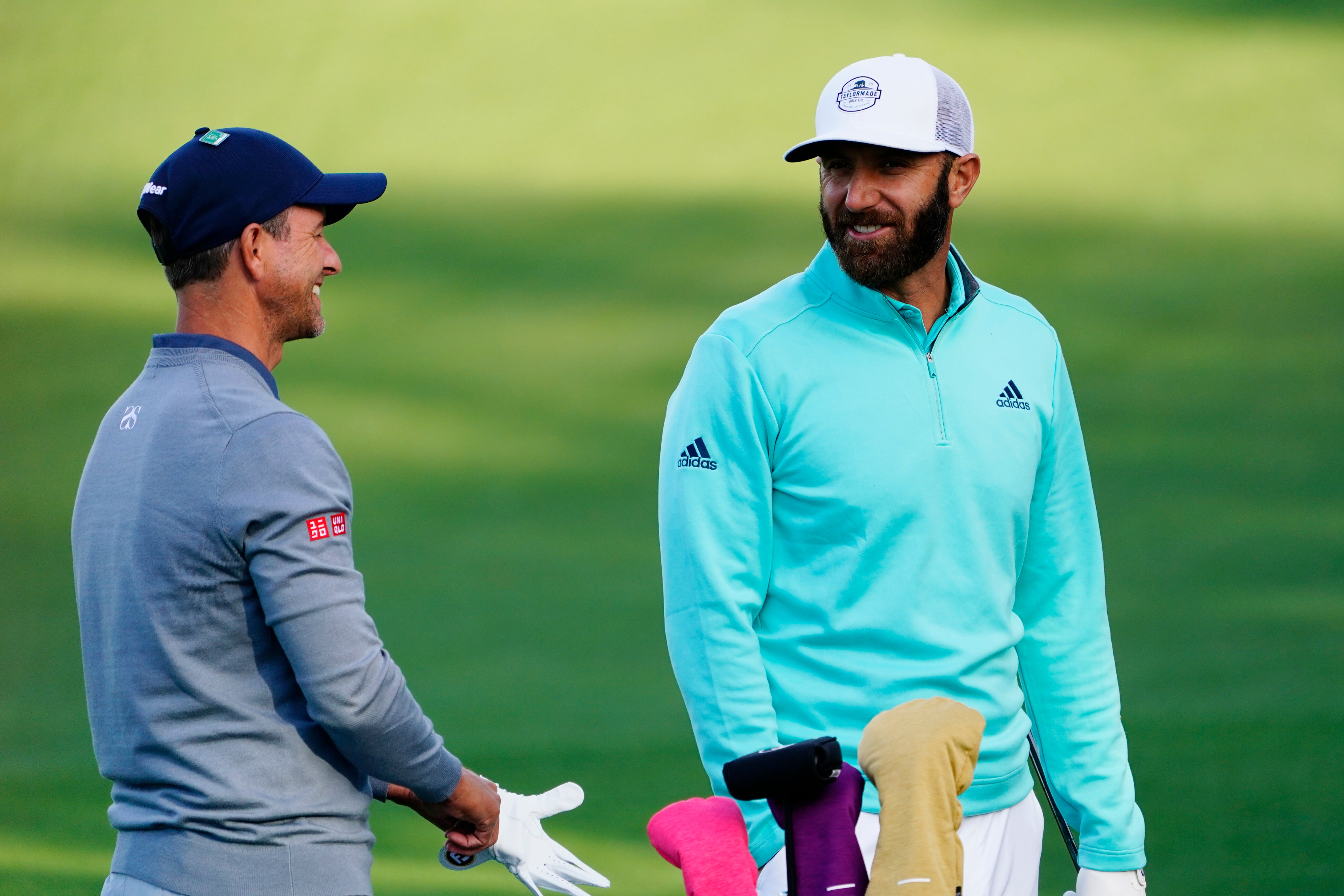 Adam Scott (left) and Dustin Johnson chat on the driving range during a practice round for the Masters (Matt Slocun/AP)
