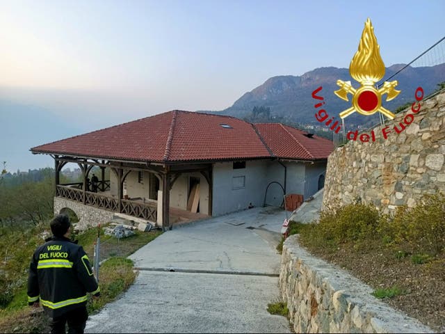 <p>A firefighter walks by the Menaggio villa owned by Vladimir Soloviev on Wednesday</p>