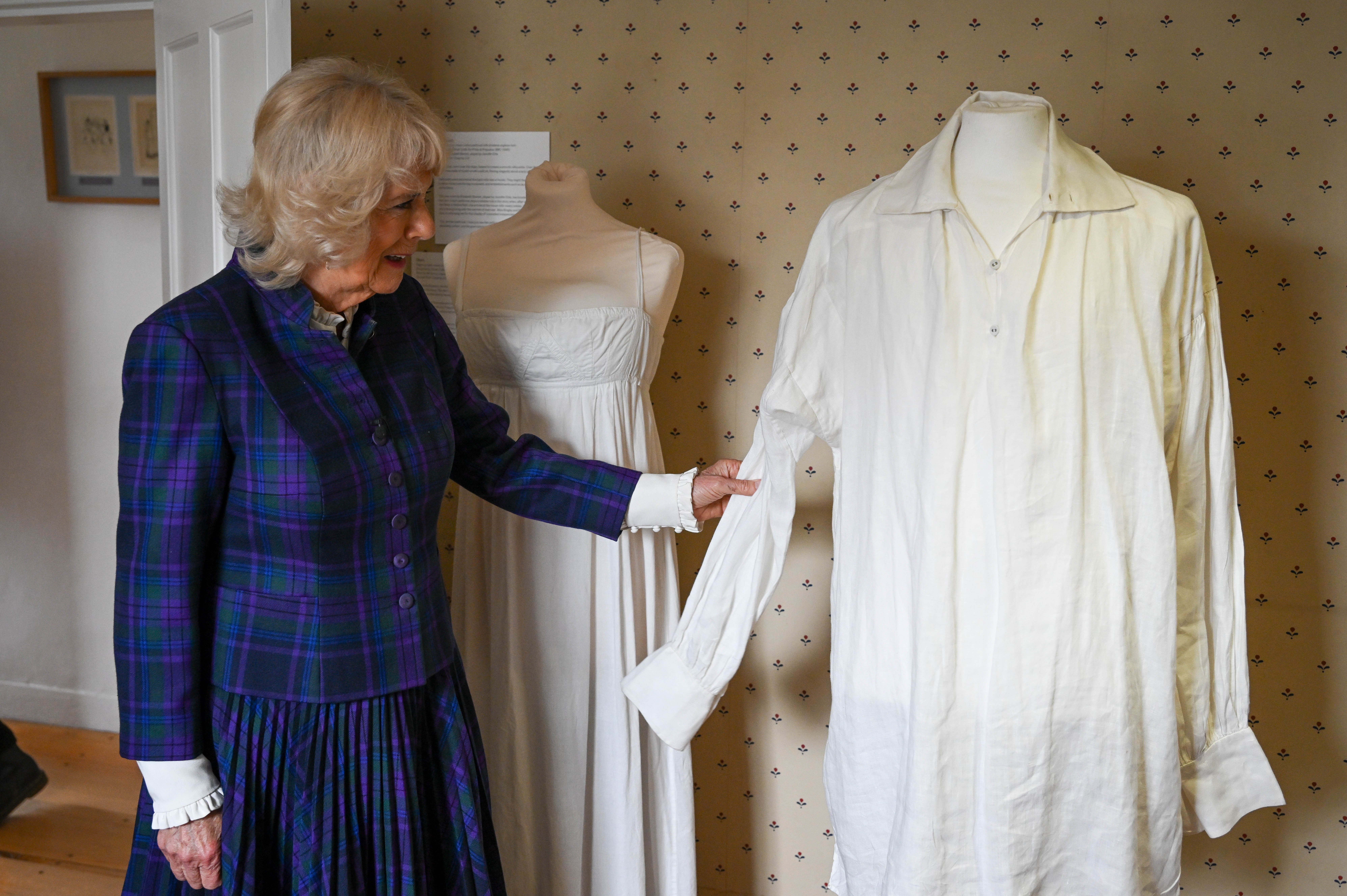 Camilla inspects the famous white shirt (Finnbarr Webster/PA)