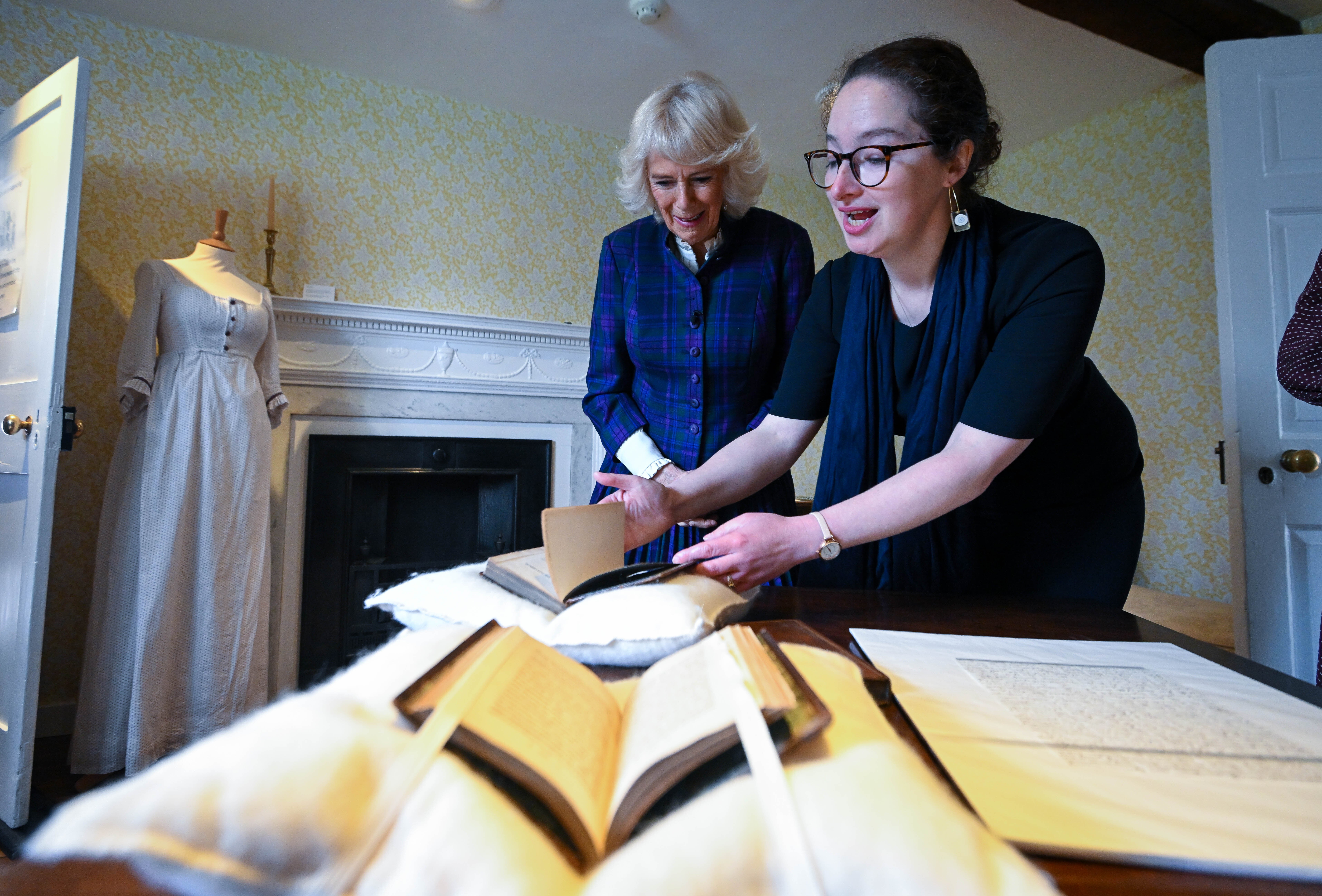 Lizzie Dunford shows Camilla a first edition of Pride And Prejudice (Finnbarr Webster/PA)