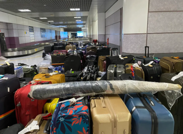 <p>Piles of abandoned bags at Manchester Airport </p>