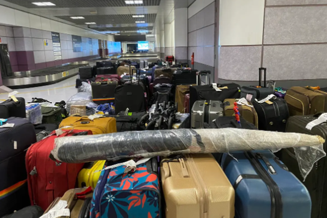 <p>Piles of abandoned bags at Manchester Airport </p>