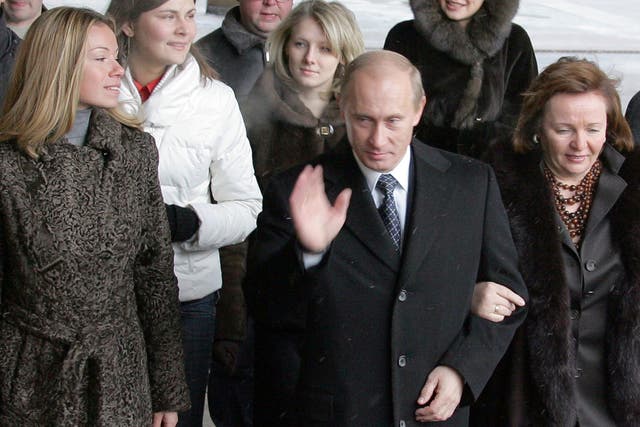 <p>Russian president Vladimir Putin, with his ex-wife Ludmila and their daughter Maria (left) at a Moscow polling station in December 2007</p>