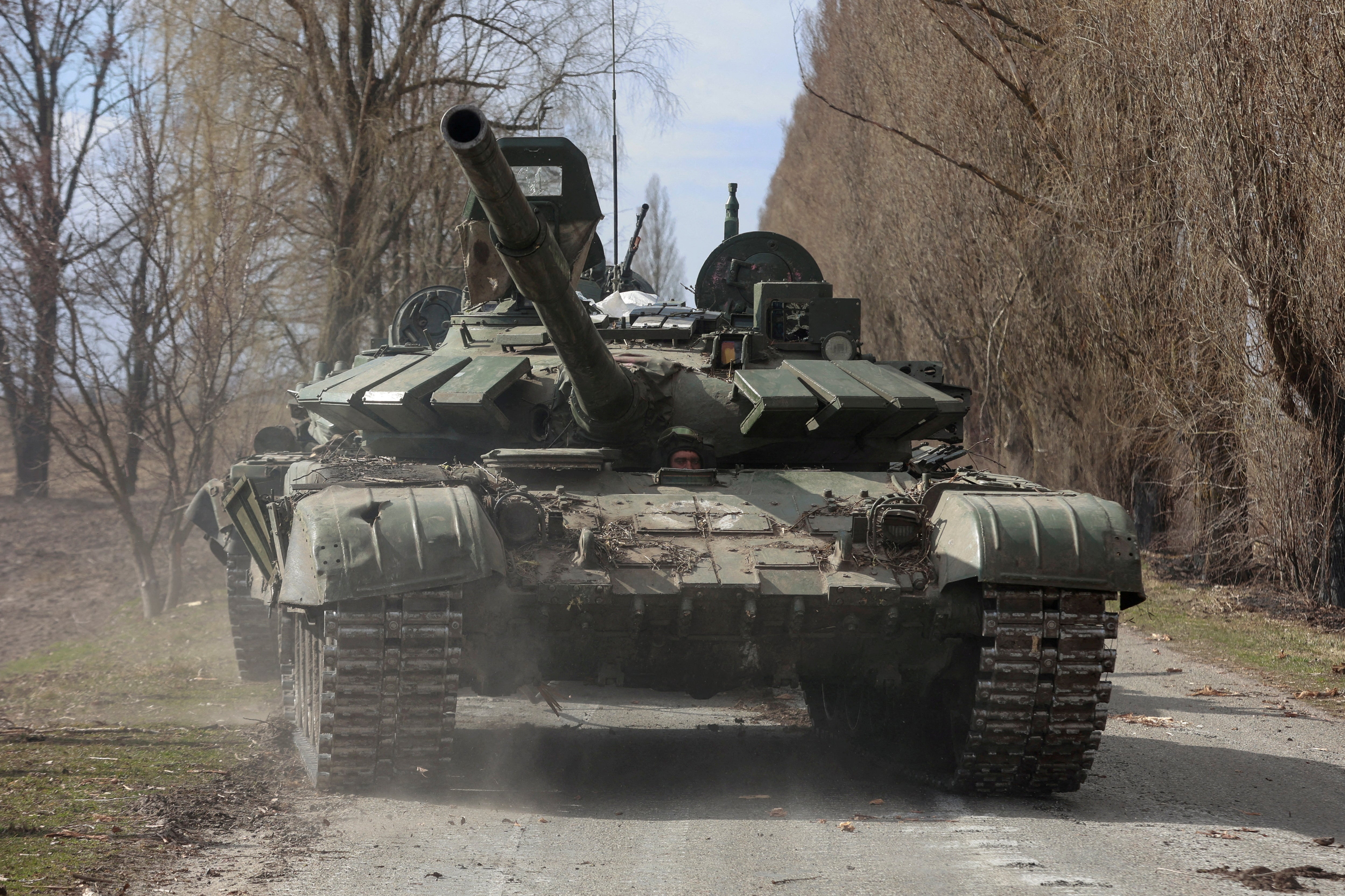 A Russian T-72 tank is driven by a Ukrainian soldier after being captured near Kyiv on 27 March 2022