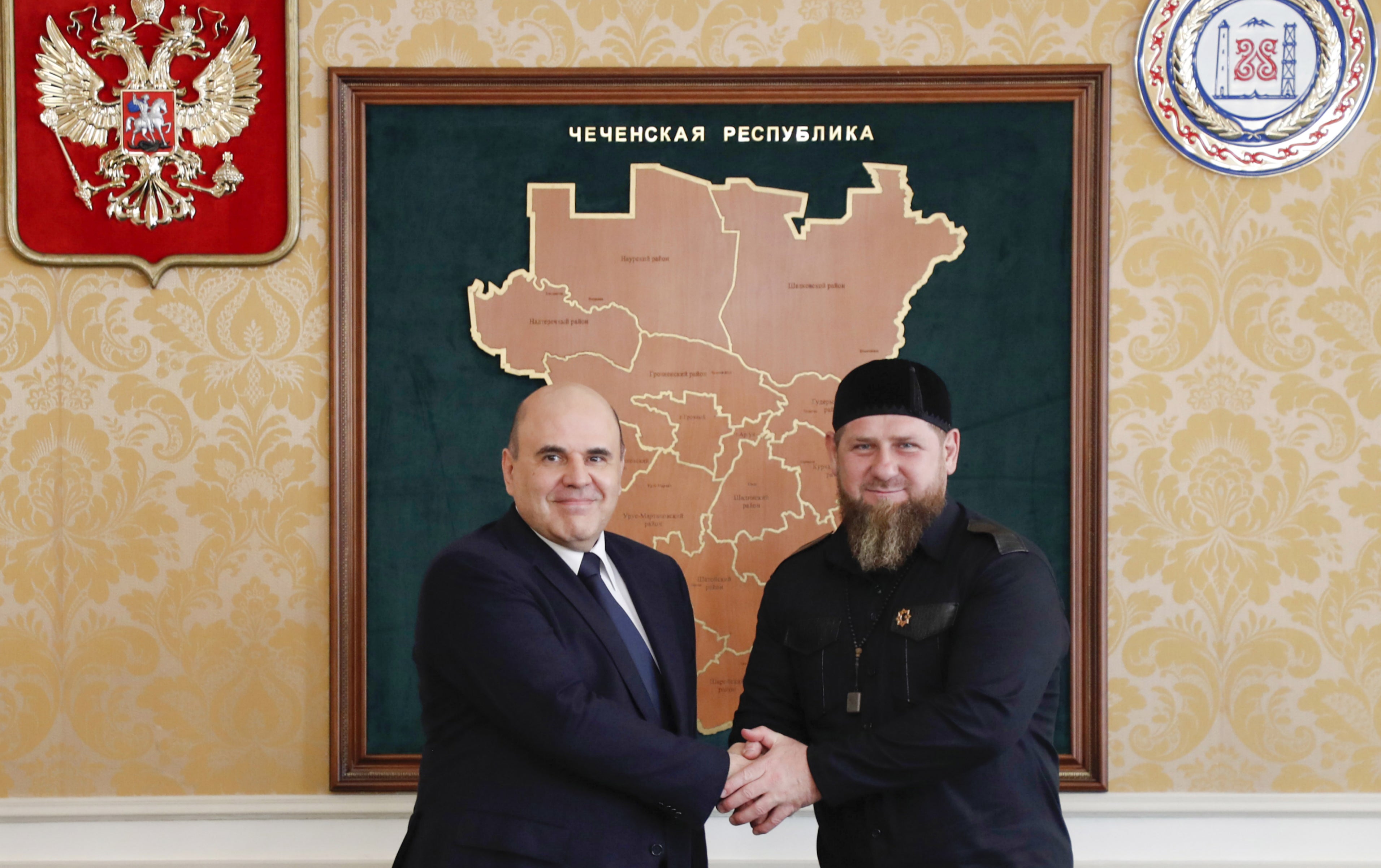 The Russian prime minister, Mikhail Mishustin, and Kadyrov shake hands during their meeting in Grozny, 23 April 2021