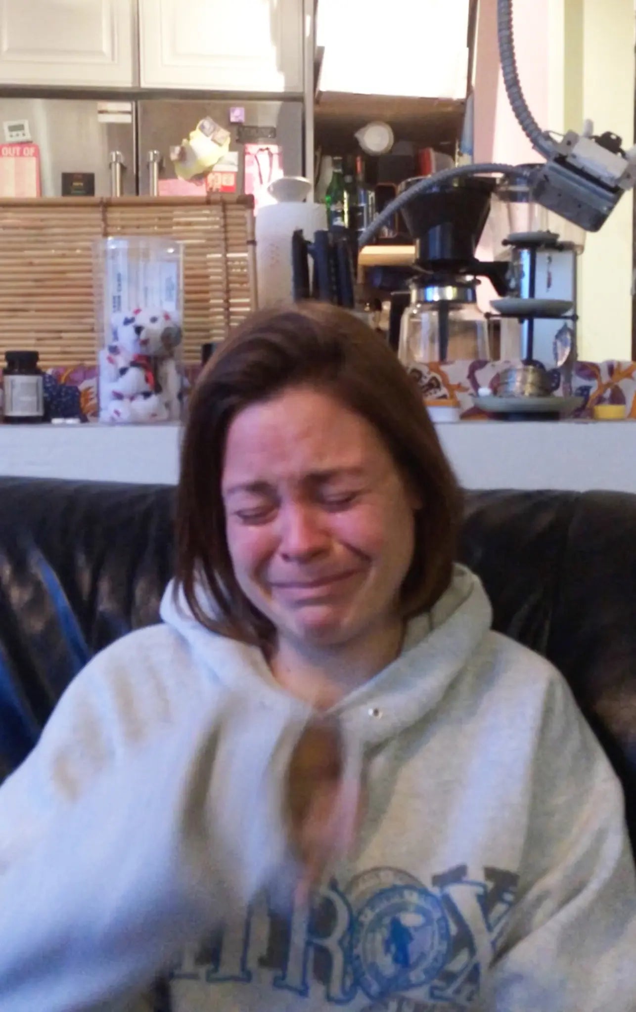 Claudia Drury, who Ray allegedly forced into being a sex worker and exploited for millions, is pictured in a sweatshirt crying.