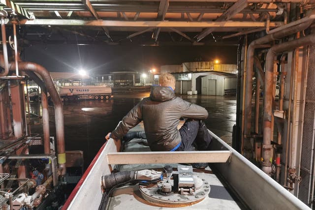 <p>A protester sits atop a tanker at the Kingsbury Oil Terminal</p>