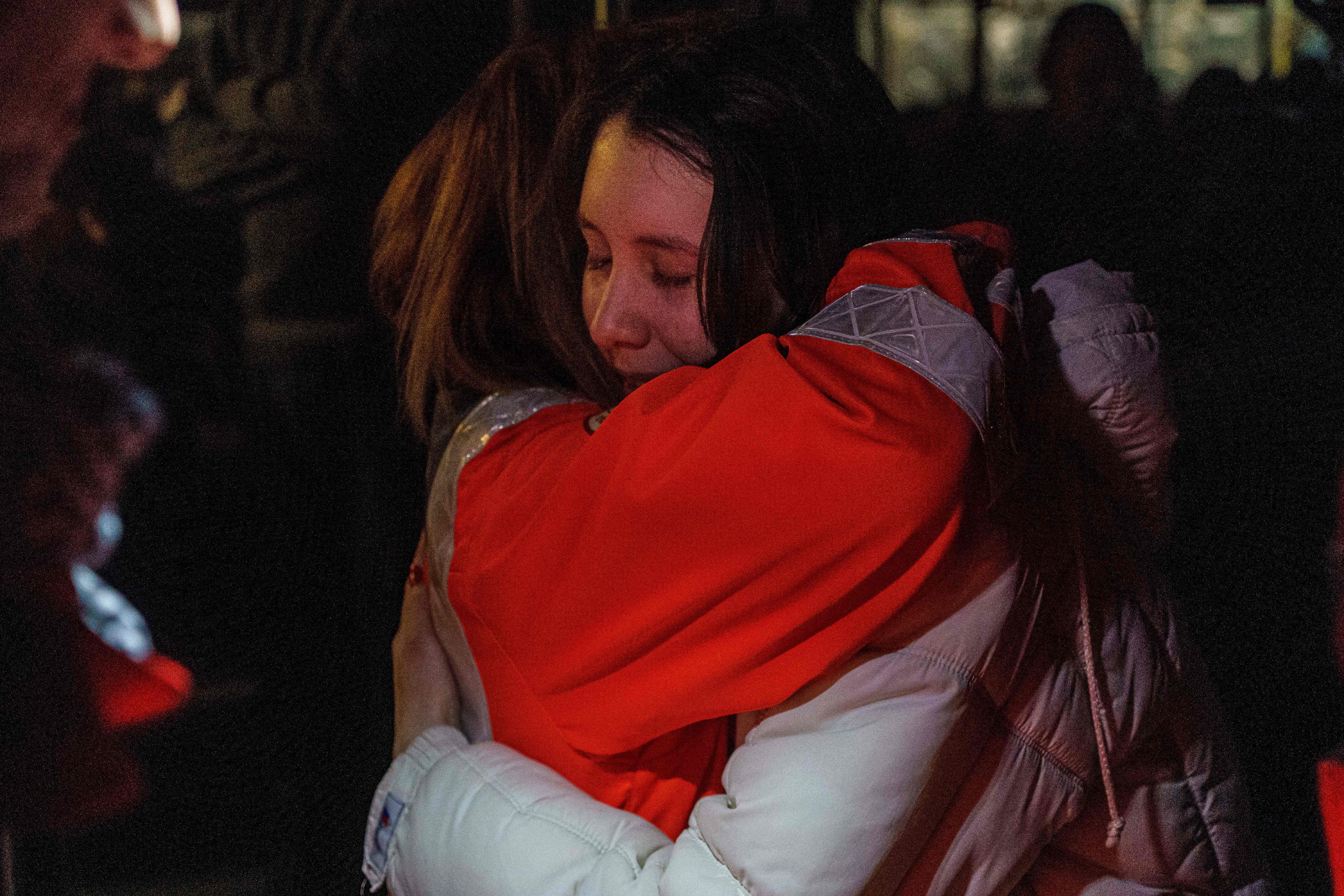 File photo: Two women hug as a convoy of 30 buses carrying evacuees from Mariupol and Melitopol arrive at the registration center in Zaporizhzhia