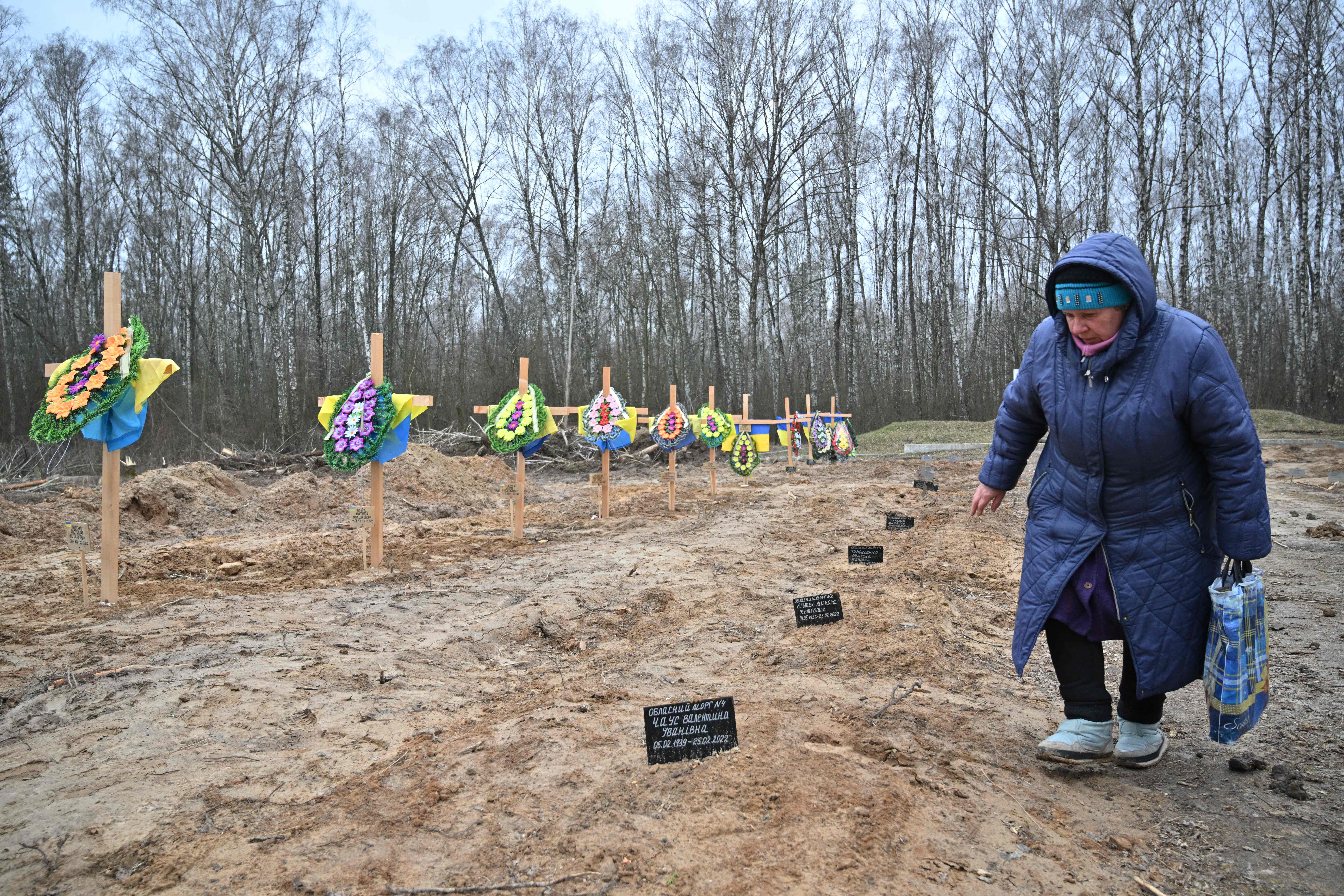 A woman searches for the grave of a relative in a cemetery in Chernigiv, northern Ukraine, 5 April 2022