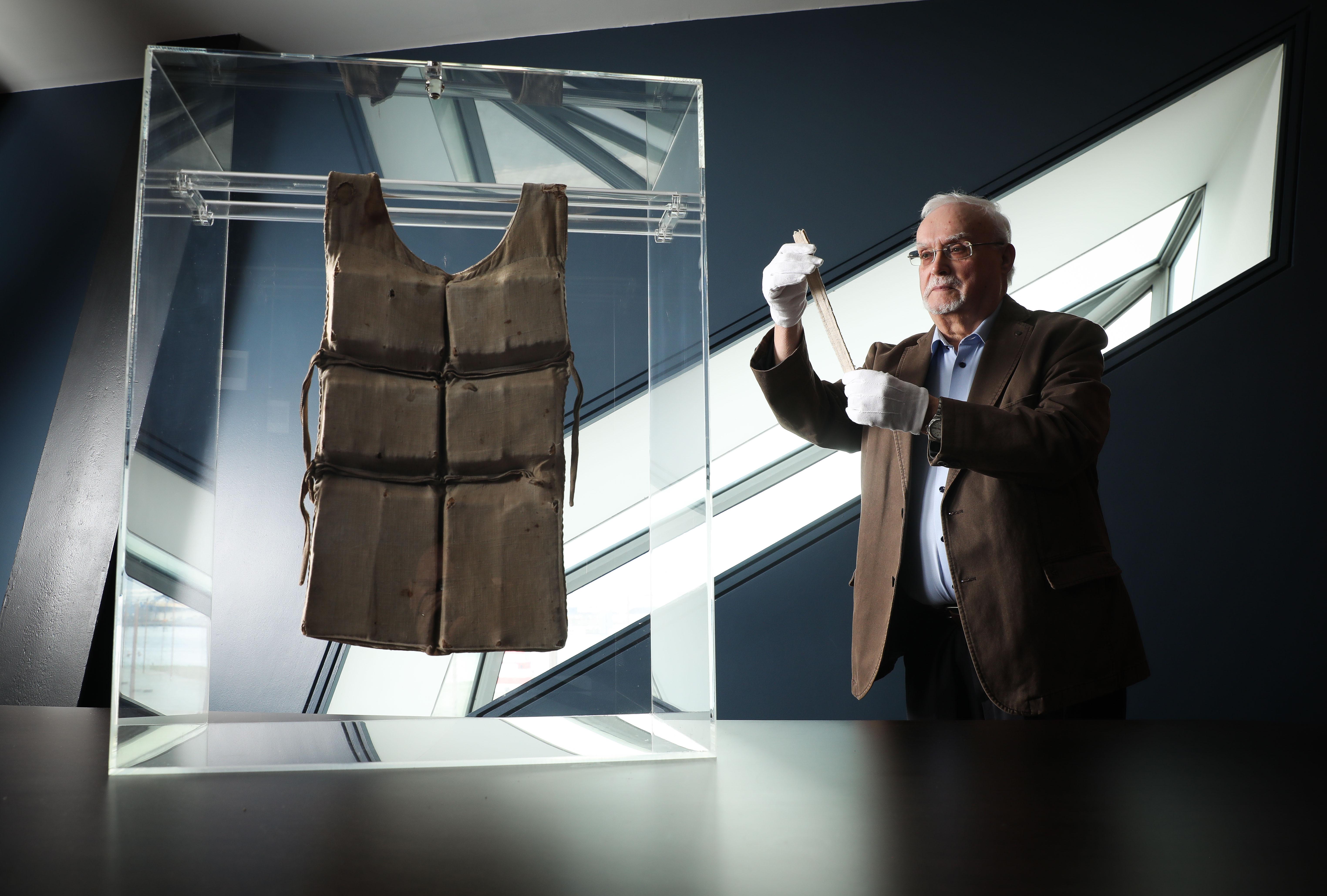 One of only six life jackets remaining from RMS Titanic has gone on display at Titanic Belfast to commemorate the 110th anniversary of the world’s most famous ship. Pictured is Rodney McCullough, Former Official Historian for Harland & Wolff preparing the artefact before it went on display. (