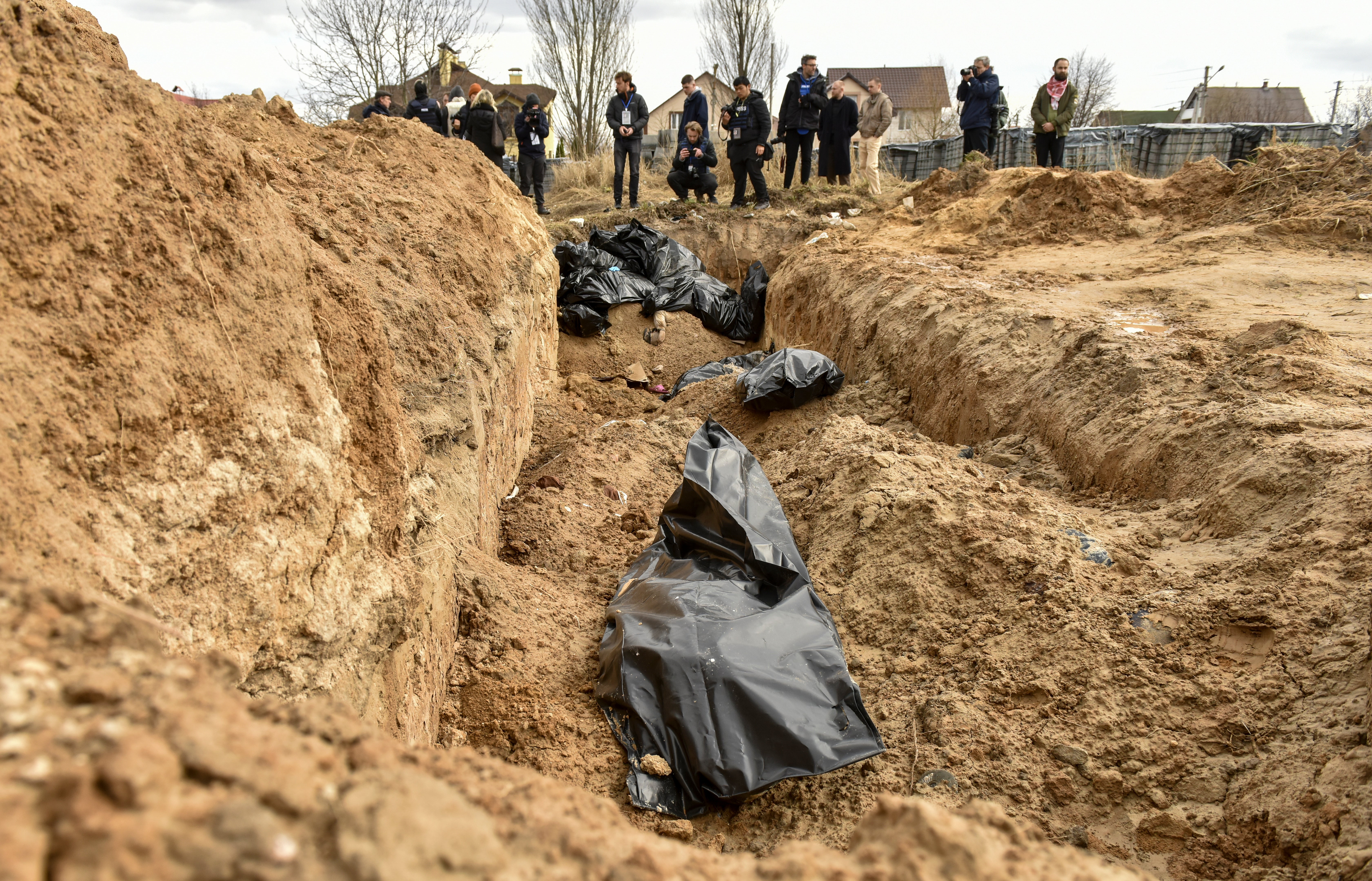 Bodies of civilians in plastic bags lay in a mass grave in Bucha, which was recently recaptured by the Ukrainian army, 4 April 2022