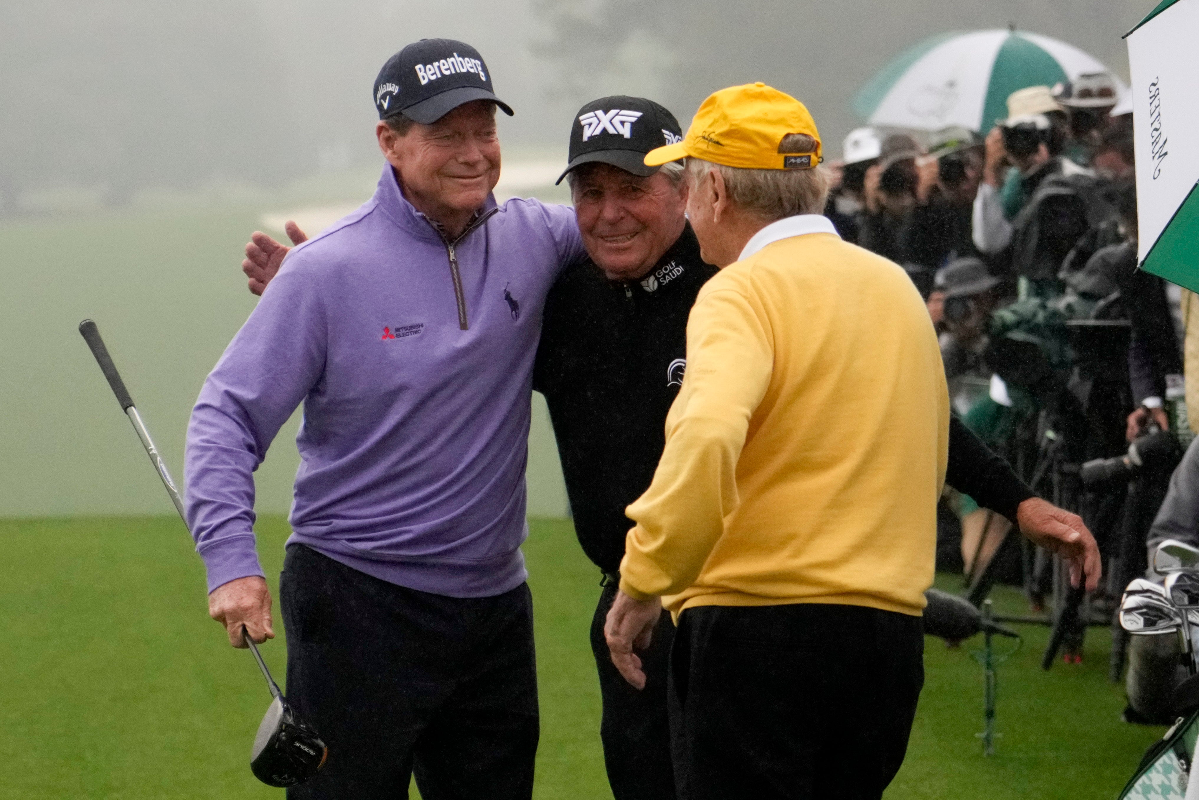 Tom Watson (left), Gary Player and Jack Nicklaus (right) hug during the honorary starter ceremony at the Masters (Charlie Riedel/AP)