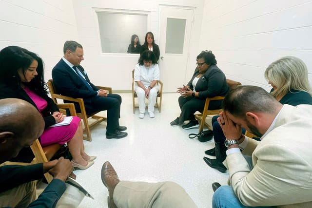<p>Texas death row inmate Melissa Lucio, dressed in white, leads a group of seven Texas lawmakers in prayer in a room at the Mountain View Unit in Gatesville, Texas</p>